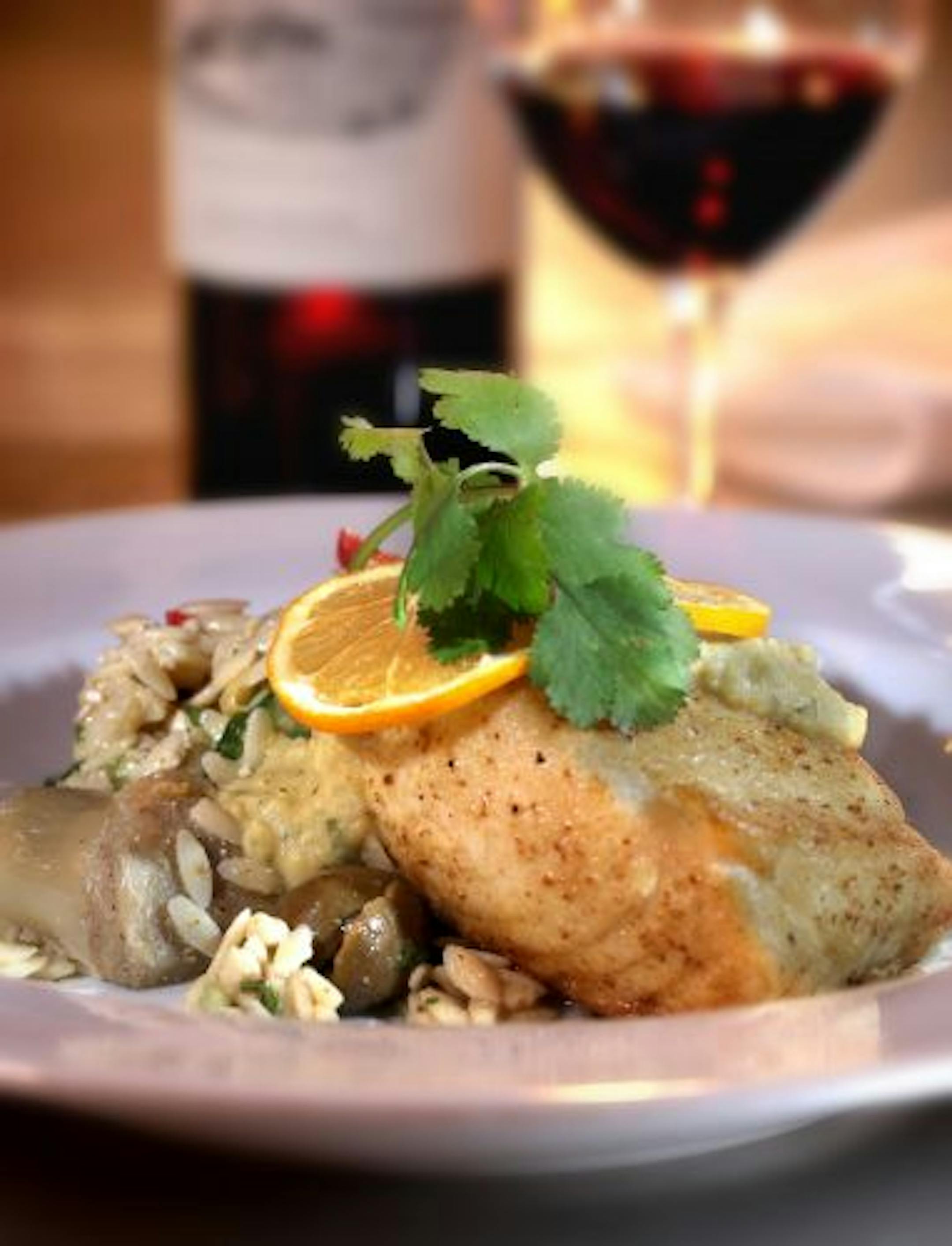 Cumin- and chickpea flour-dusted halibut, served over an orzo-olive-artichoke salad, is a daily fish special that merits the word "special."