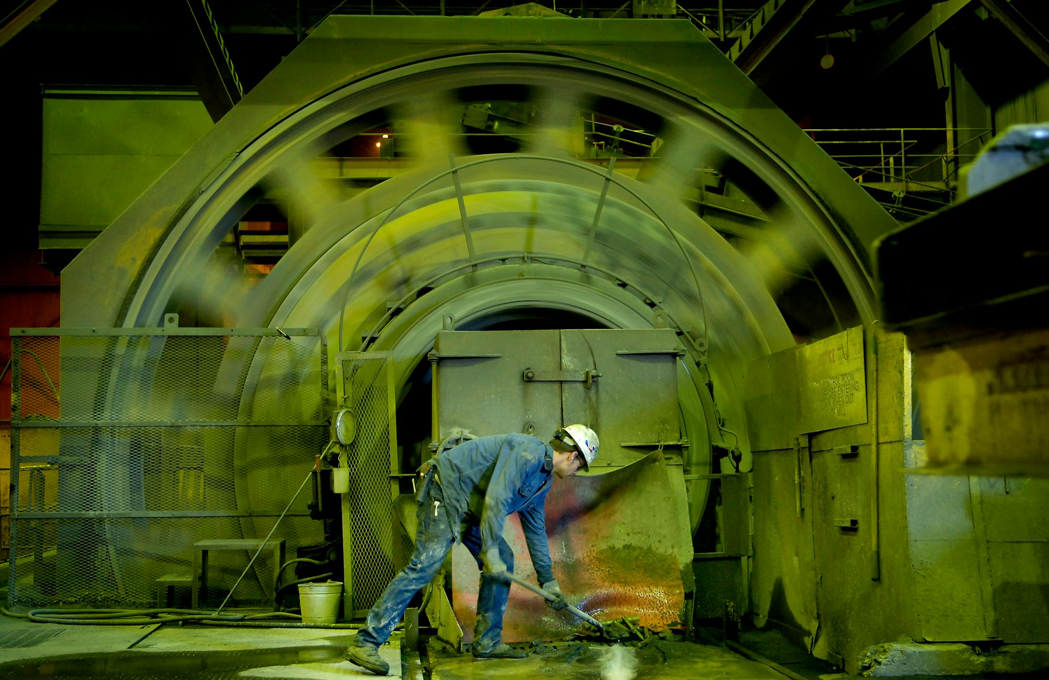 GLEN STUBBE � gstubbe@startribune.com MONDAY, October 2, 2006 -- Forbes, Minn. -- Chan Paine shoveled broken crusher rods from an opening in one the rotating mills that reduce taconite ore to powder. Paine, 20, was one of 24 new workers to be hired at United Taconite, the first new hires in 13 years.