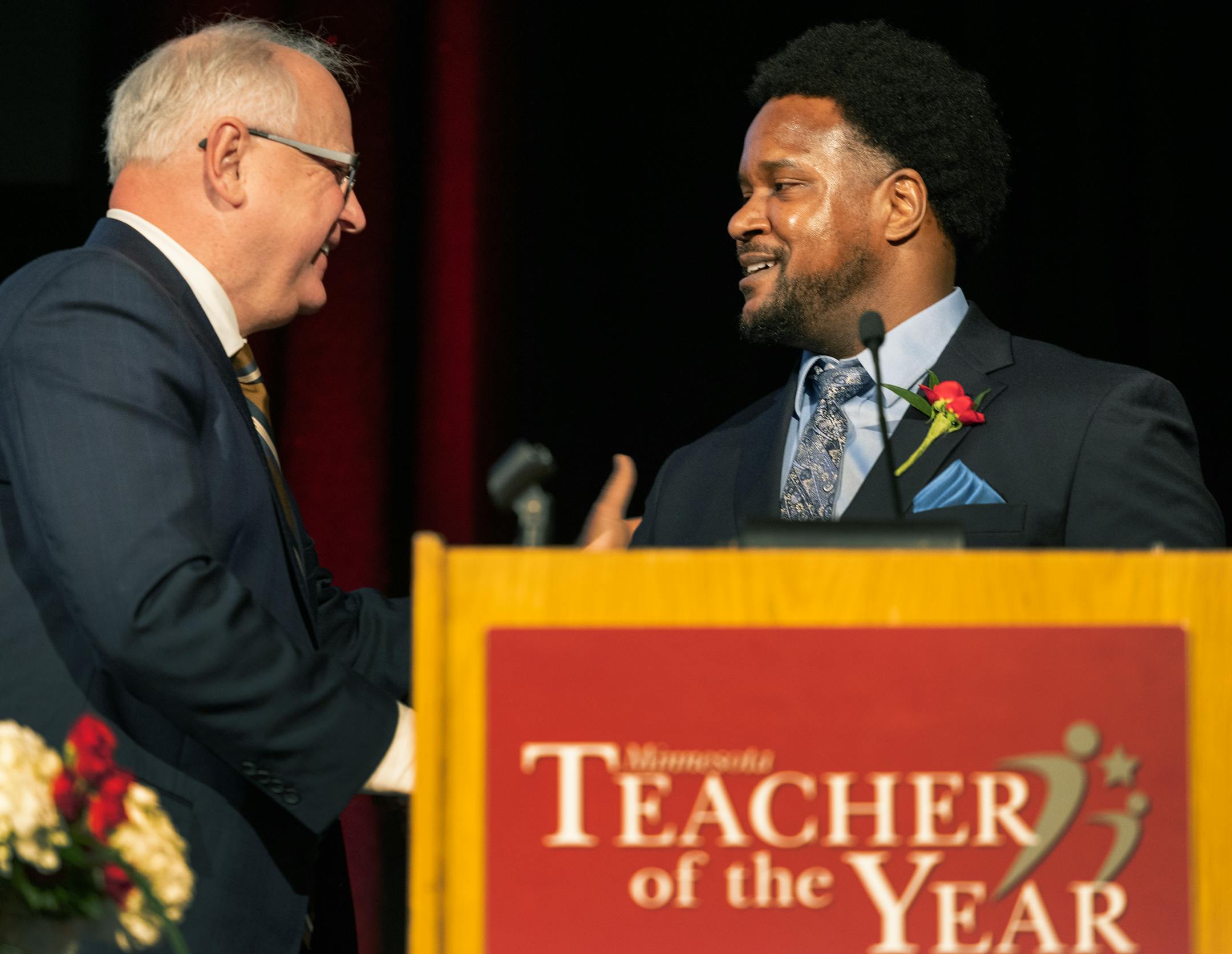 Governor Tim Walz congratulates Michael Houston, a mathematics teacher at Harding High School in St. Paul Public Schools, after being named 2023 Minnesota Teacher of the Year.
