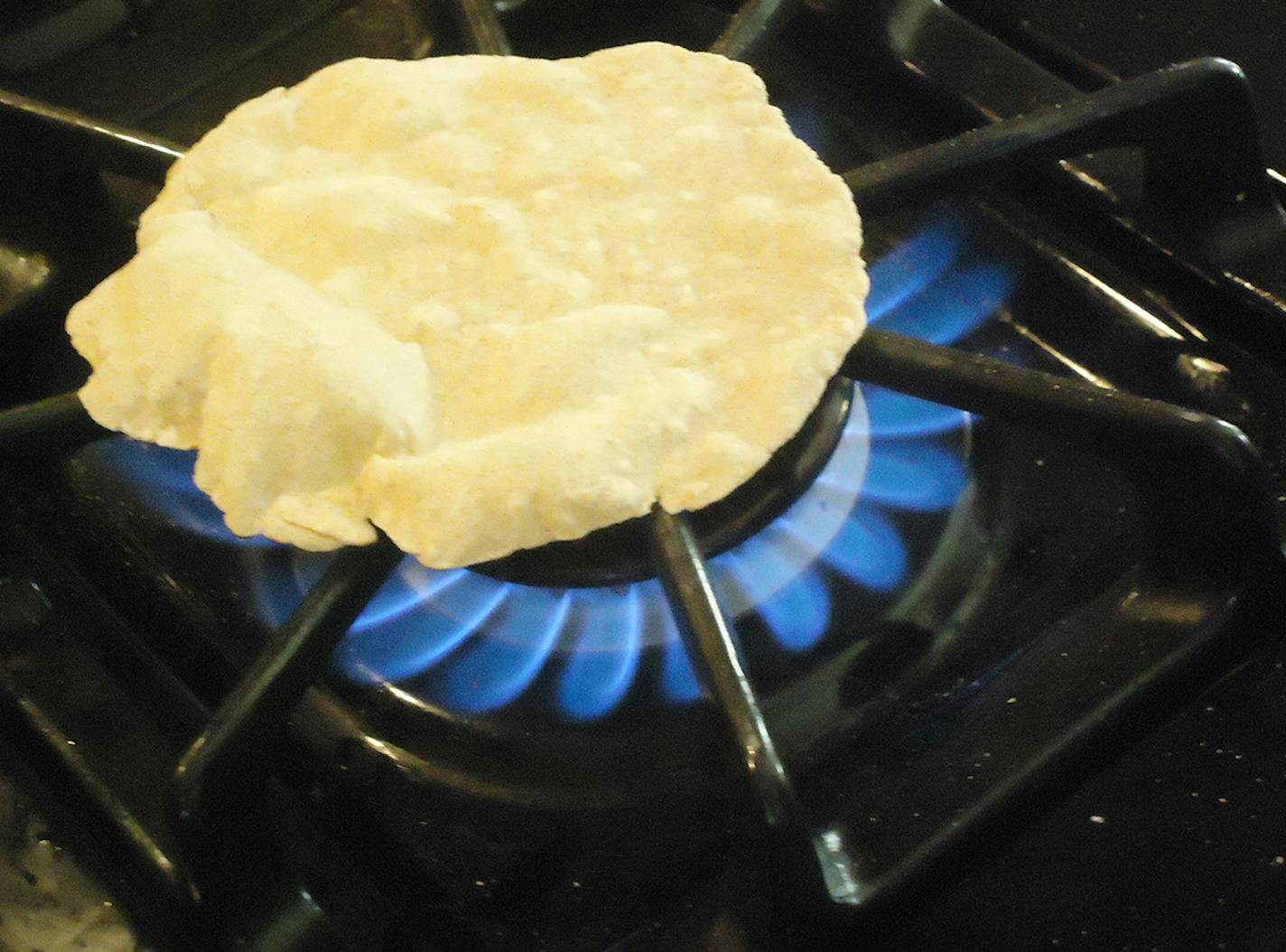 After the dough is rolled into circles, it's cooked over an open flame (but a grill or skillet works well, too).