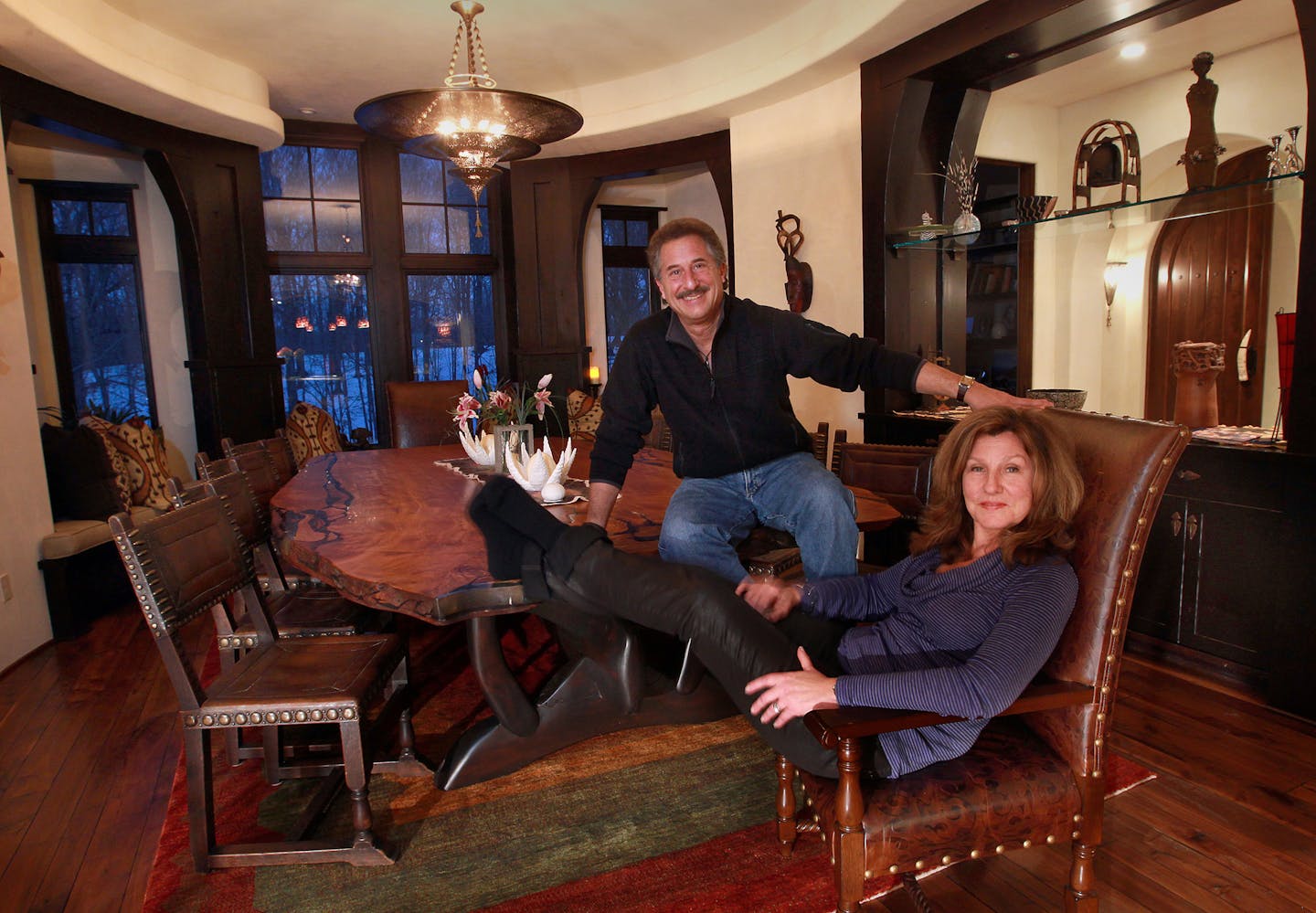 ___ Cass and Andy Stillman, built a unique home with architectural details inspired by the homeowners' love of Africa, i.e. wooden monkeys carved into the doors, stone elephants flanking the fireplace, African motifs inlaid into floors and carved into cupboards with lots of treasures picked up in their world travels. It includes a gallery for their African art and hosting fundraisers in support of African causes, is a perfect fit for the home and the couple. [ TOM WALLACE &#x201a;&#xc4;&#xa2; tw