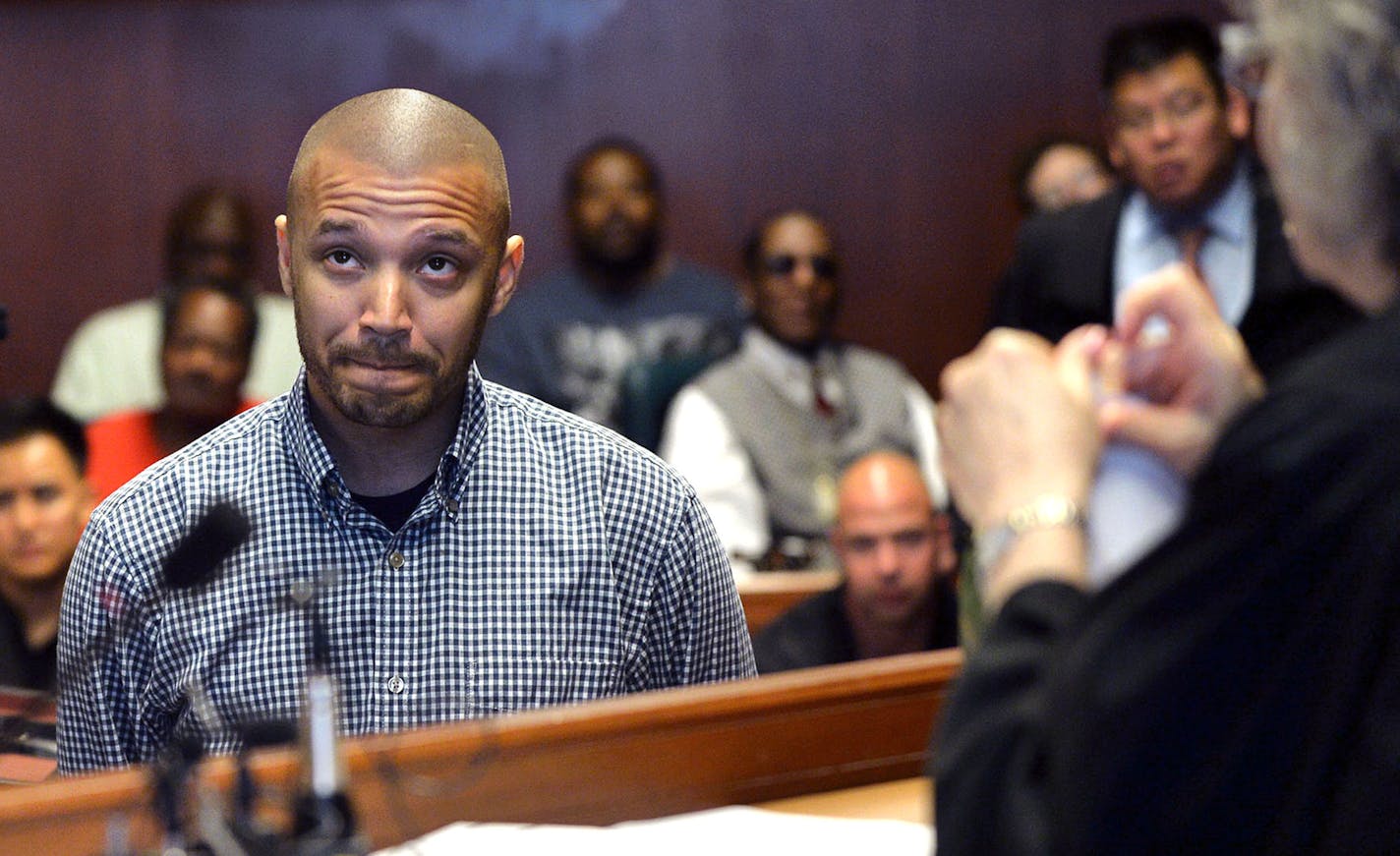 From left, James Martin, the mentor to Veteran graduate Charles King, center, both reacted as Judge Judith Tilsen tore up King's plea petition. By tearing up his plea petition, King's charge is no longer on his record. The Veterans graduation ceremony was held in the Ramsey County District Court in St. Paul, Minn., on Thursday July 9, 2015. The Ramsey County Veterans Treatment Court held a graduation ceremony for four veterans. ] RACHEL WOOLF &#x2211; rachel.woolf@startribune.com ORG XMIT: MIN15