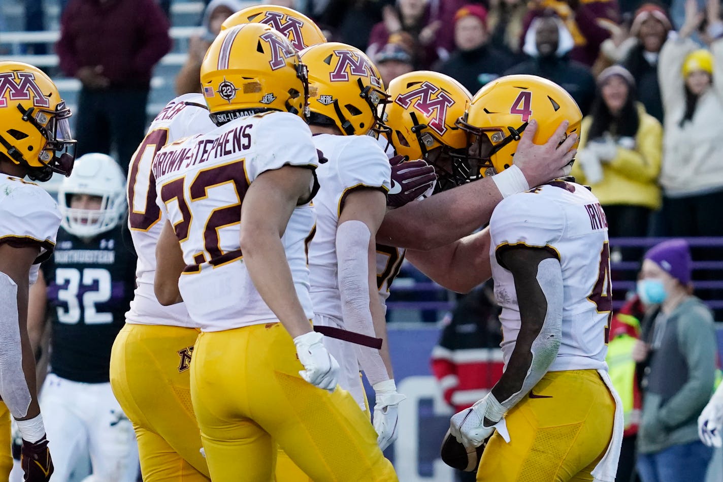 Minnesota running back Mar'Keise Irving, right, celebrates with teammates after scoring a touchdown run during the second half of an NCAA college football game in Evanston, Ill., Saturday, Oct. 30, 2021. Minnesota won 41-14. (AP Photo/Nam Y. Huh)