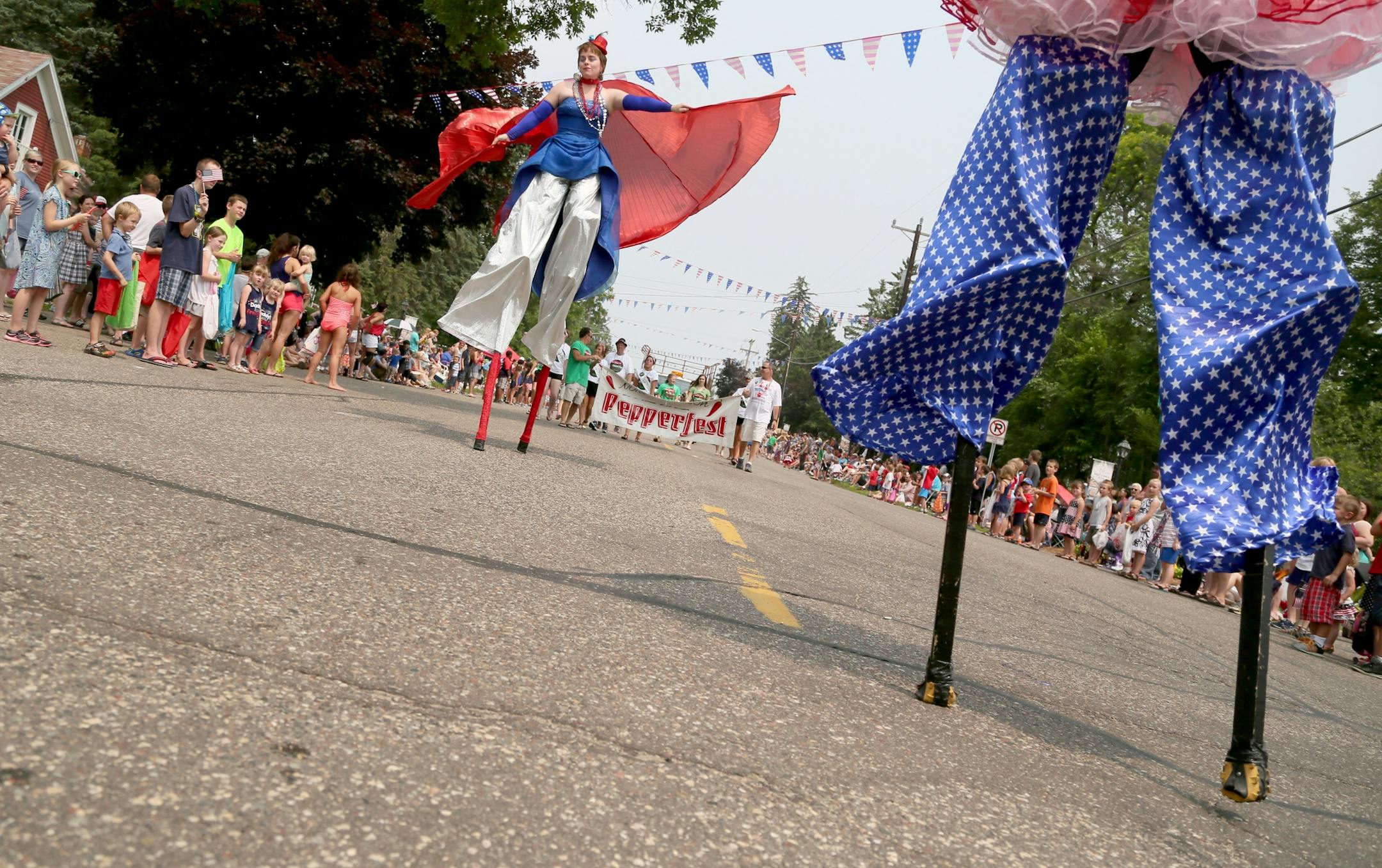 Stilt walkers from Chicks on Stilts of Minneapolis towered above parade goers during the July 4th parade in downtown Afton, MN, Saturday, July 4, 2015.