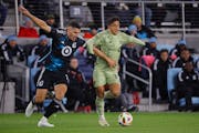 Los Angeles FC forward Cristian Olivera, right, dribbles the ball as Loons defender Michael Boxall defends during the first half Saturday night at All