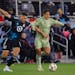 Los Angeles FC forward Cristian Olivera, right, dribbles the ball as Loons defender Michael Boxall defends during the first half Saturday night at All