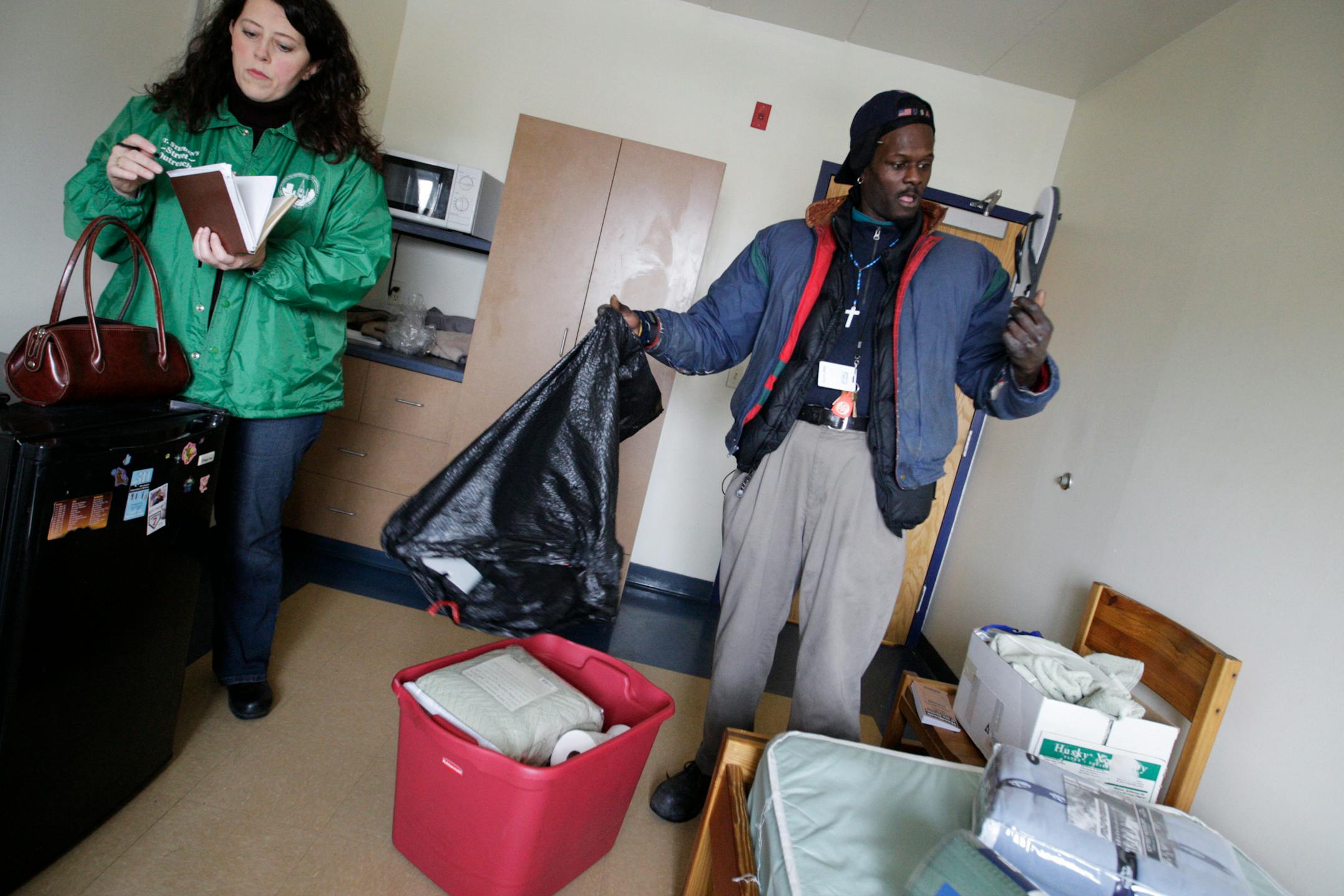 St. Stephen's Human Services director Monica Nilsson helped Darrell Walton get situated in his new apartment at Evergreen Residence for the homeless. Walton has been arrested in Minneapolis 102 times for begging, loitering and trespassing.