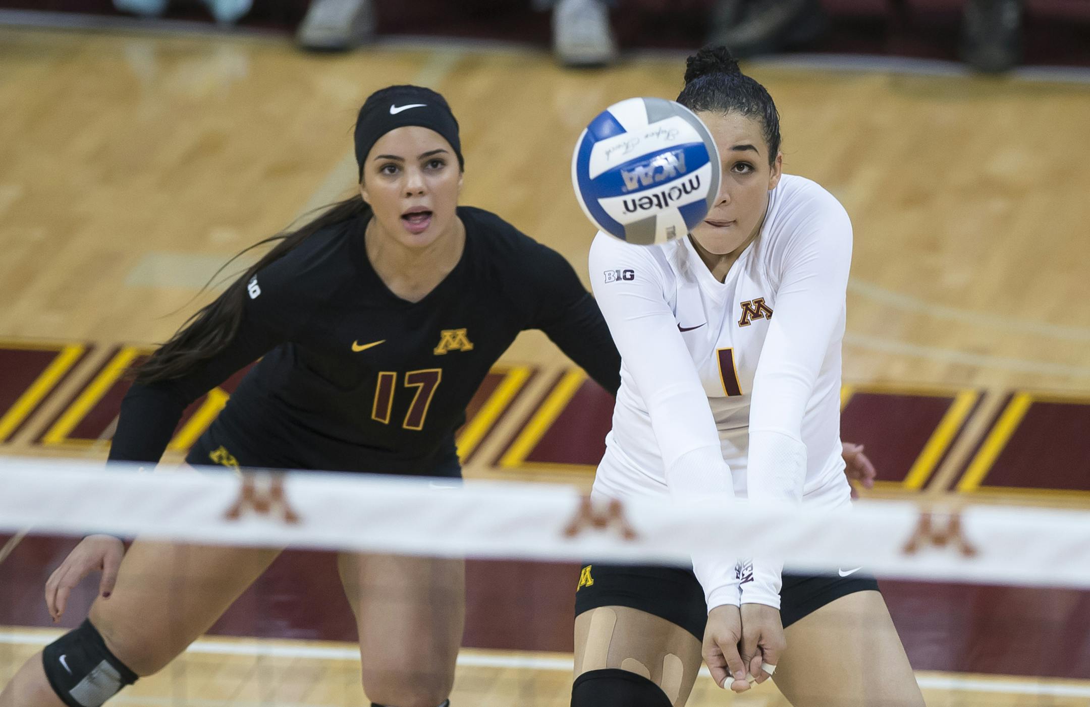 Minnesota libero Dalianliz Rosado (17) eyed the ball as outside hitter Daly Santana (1) went for a bump in the second set Saturday against Marquette. ] (AARON LAVINSKY/STAR TRIBUNE) aaron.lavinsky@startribune.com The University of Minnesota Golden Gophers women’s volleyball team played Marquette in the second round of the NCAA tournament on Saturday, Dec. 5, 2015 at the University of Minnesota Sports Pavilion in Minneapolis, Minn. ORG XMIT: MIN1512051950370149