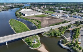 An aerial photo shows Hall's Island on the East Bank of the Mississippi River in Minneapolis. Graco Park is in the background on shore, followed by Gr