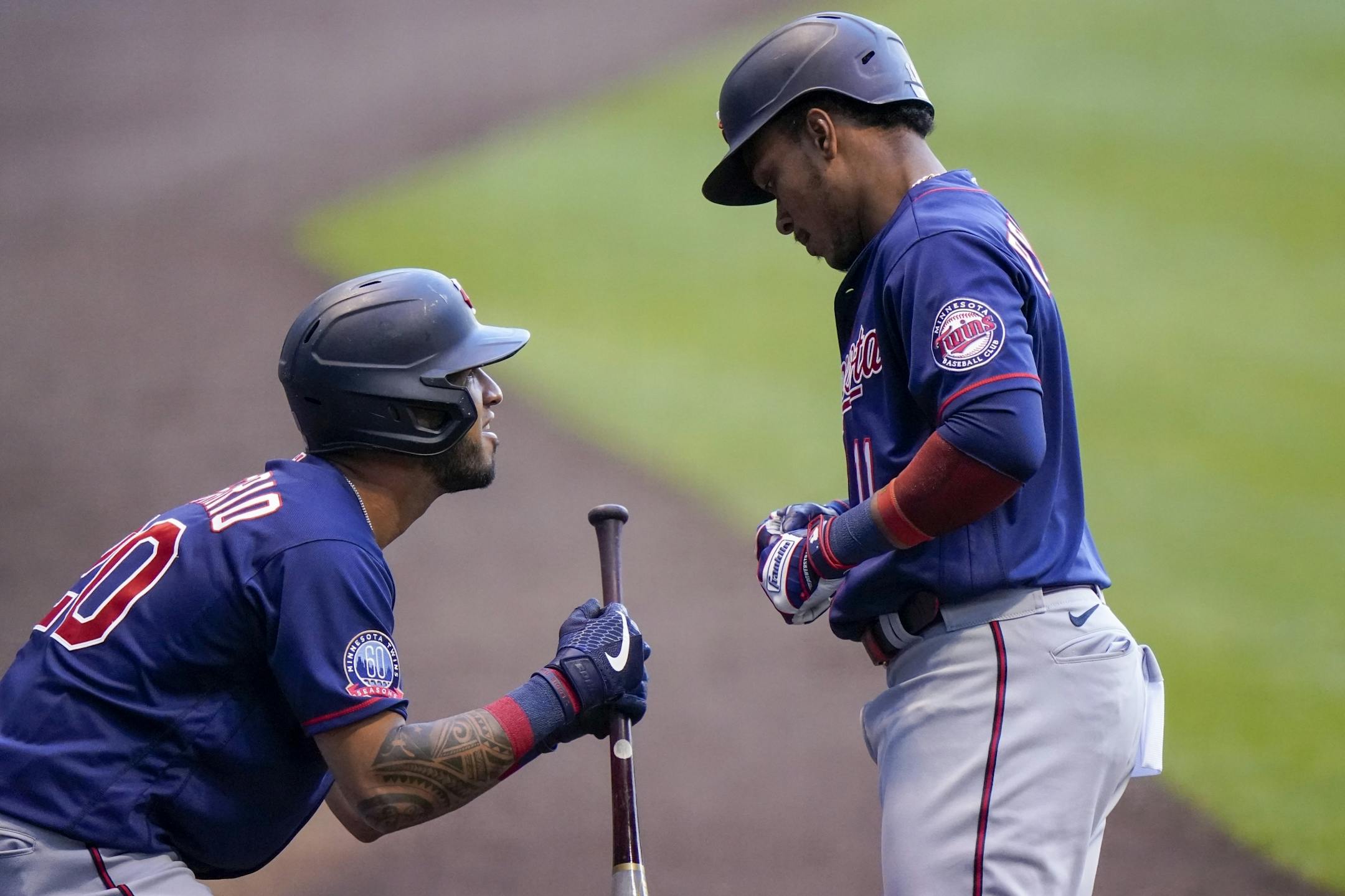 Minnesota Twins' Eddie Rosario (20) congratulates Jorge Polanco after Polanco's home run during the first inning of a baseball game against the Milwaukee Brewers Tuesday, Aug. 11, 2020, in Milwaukee.
