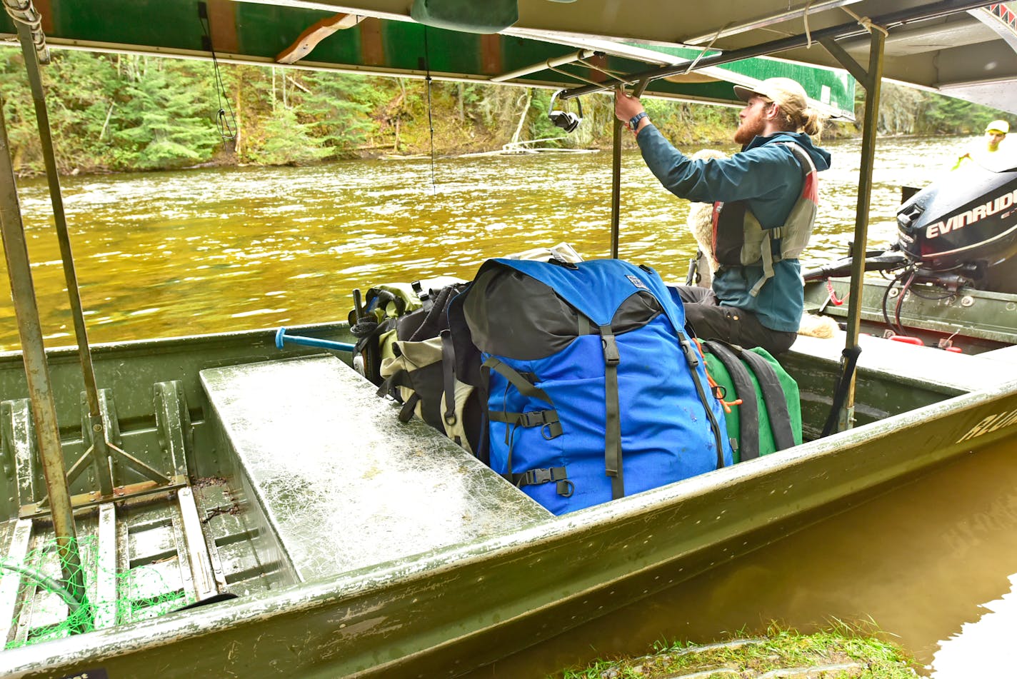 Patrick, a tow boat operator who works for an outfitter on Moose Lake near Ely, ties down the second of two canoes for a group of paddlers leaving the BWCA.