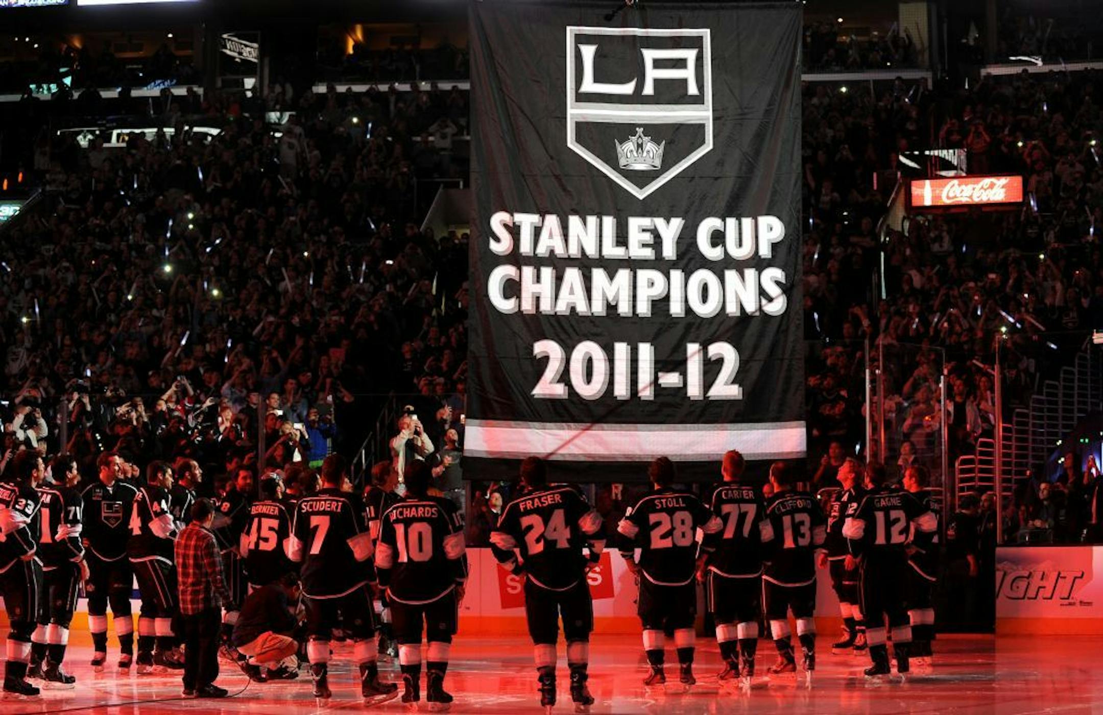 The Los Angeles Kings watch the championship banner rise during ceremonies prior to action against the Chicago Blackhawks at Staples Center in Los Angeles, California, on Saturday, January 19, 2013.