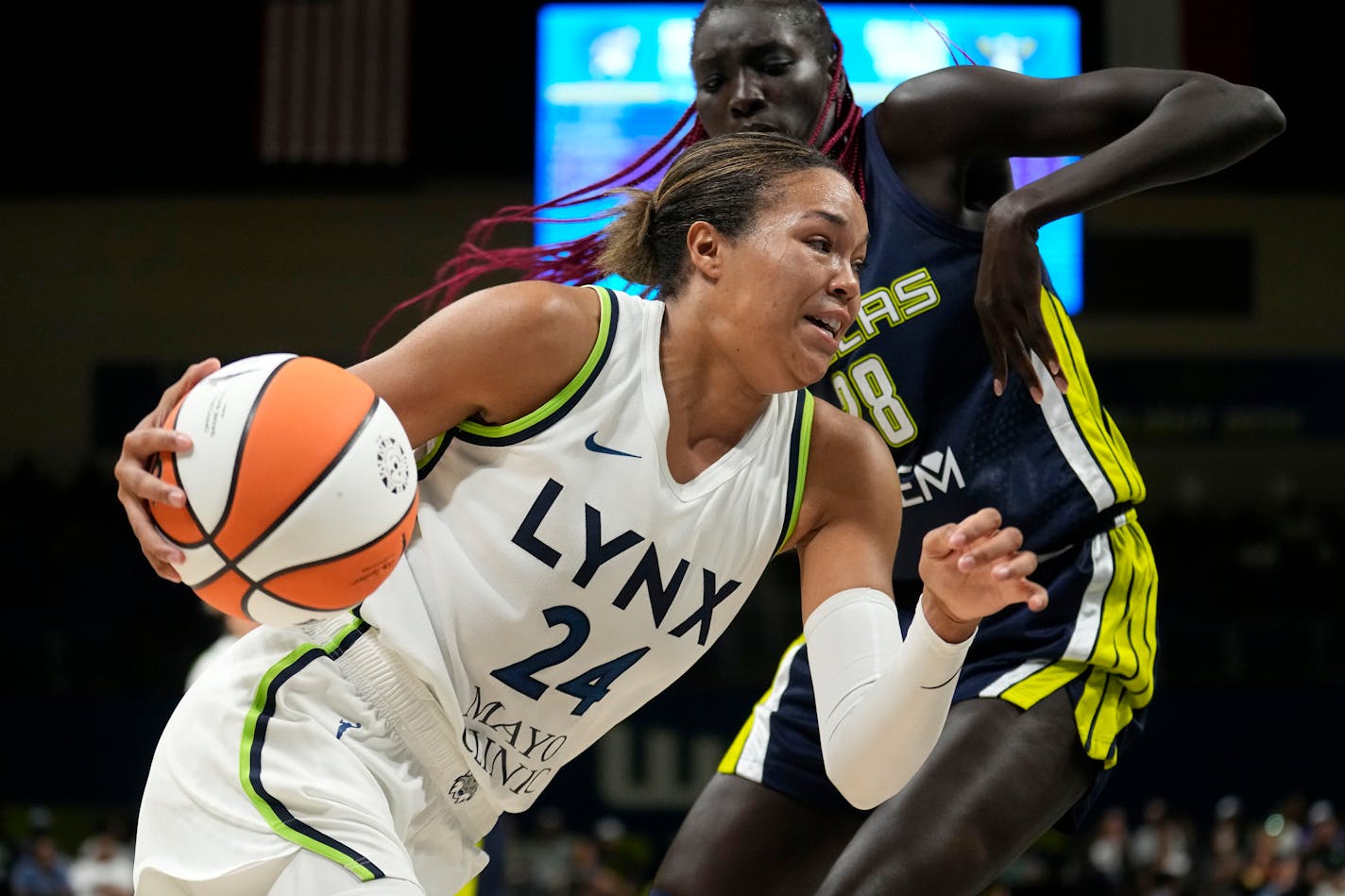 Minnesota Lynx forward Napheesa Collier (24) drives the lane to the basket as Dallas Wings center Awak Kuier, right, defends in the second half of a WNBA basketball game, Thursday, Aug. 24, 2023, in Arlington, Texas. (AP Photo/Tony Gutierrez)