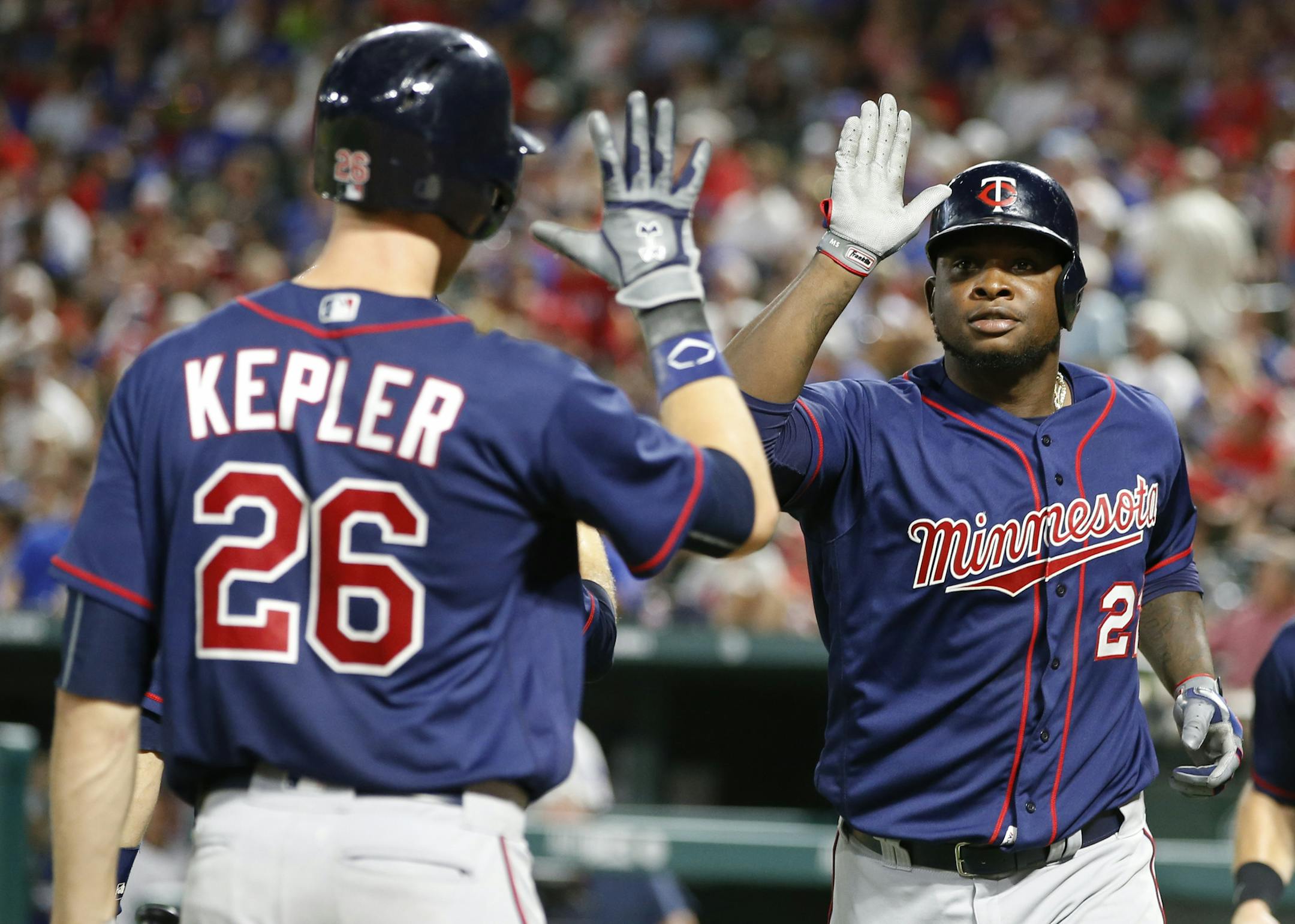 Minnesota Twins' Miguel Sano (22) celebrates his three-run home run with Max Kepler (26) against the Texas Rangers during the fifth inning of a baseball game, Friday, July 8, 2016, in Arlington, Texas. (AP Photo/Jim Cowsert)