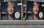 Election posters of German Chancellor Angela Merkel stand at a main street in Frankfurt, Germany, Wednesday, Sept. 20, 2017. German elections will be 