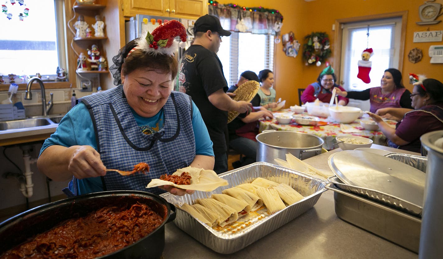 Blanca Mendez carefully placed the meat in the tamales.