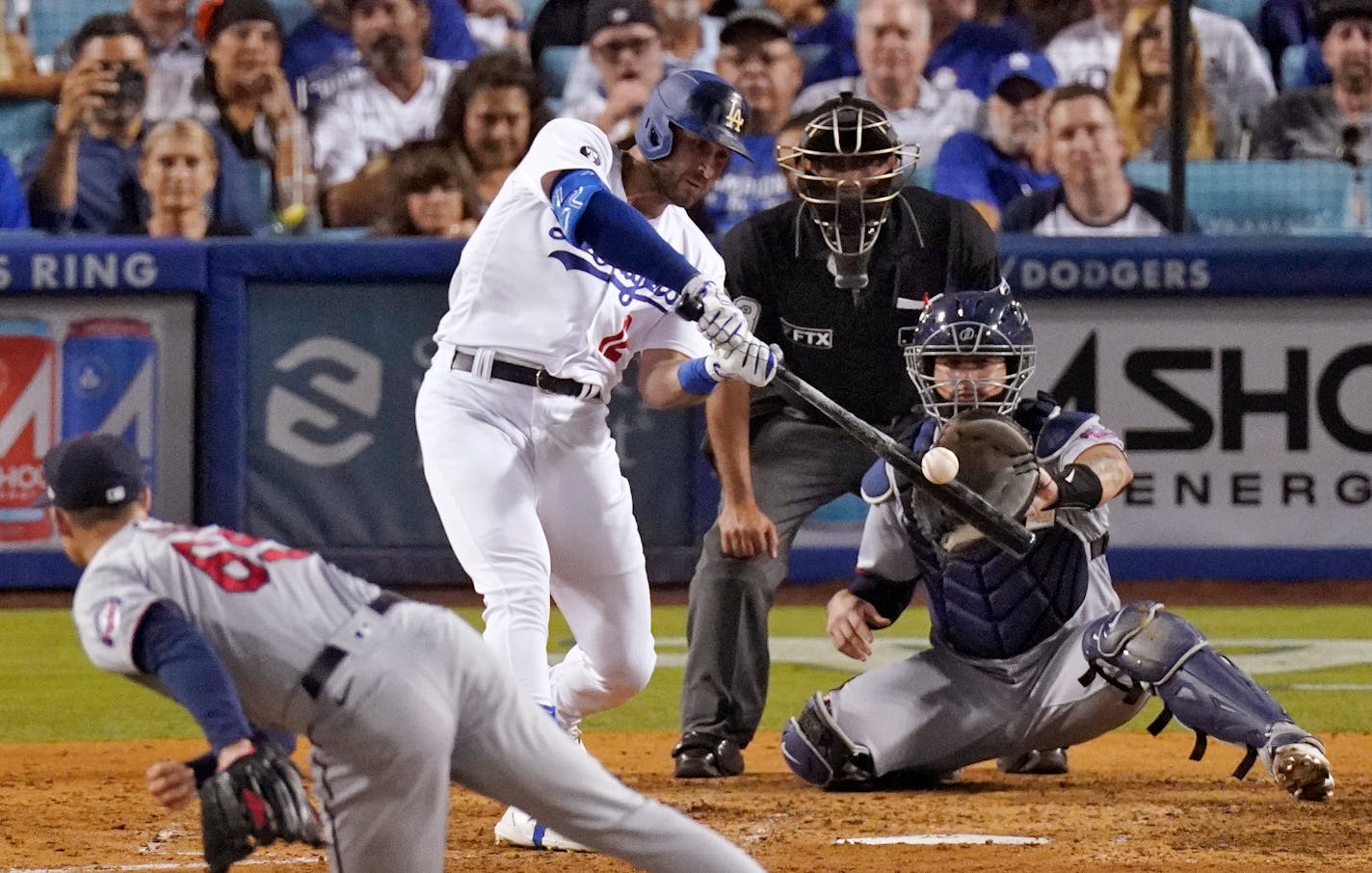 Los Angeles Dodgers' Joey Gallo, second from left, hits a three-run home run while Minnesota Twins relief pitcher Griffin Jax, left, watches along with catcher Gary Sanchez, right, and home plate umpire Nestor Ceja during the seventh inning of a baseball game Wednesday, Aug. 10, 2022, in Los Angeles. (AP Photo/Mark J. Terrill)