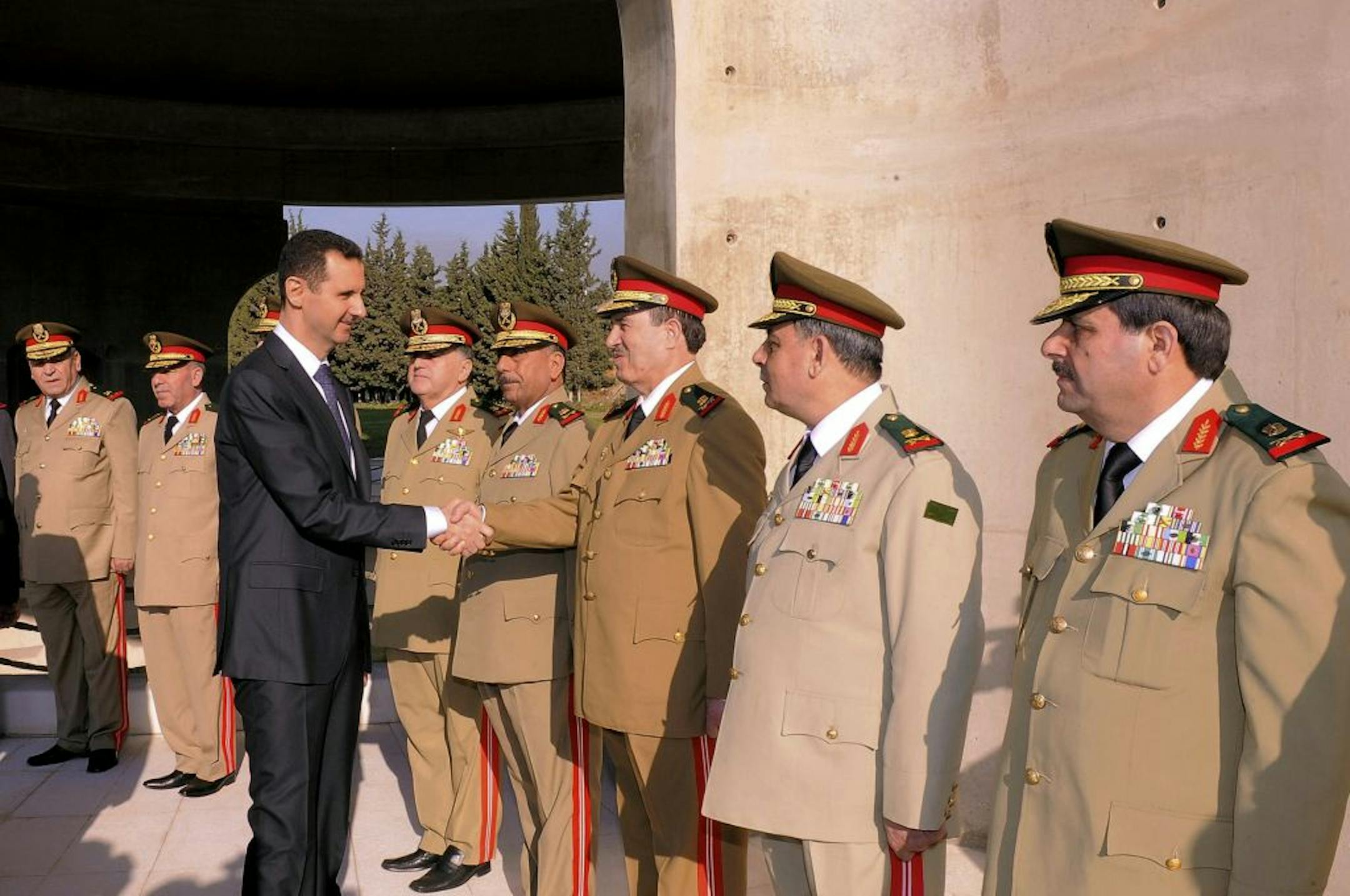 President Bashar Assad greeted military officers in a ceremony on Saturday in Damascus marking the anniversary of the 1973 Arab-Israeli war. The image was released by Syria's official news agency.