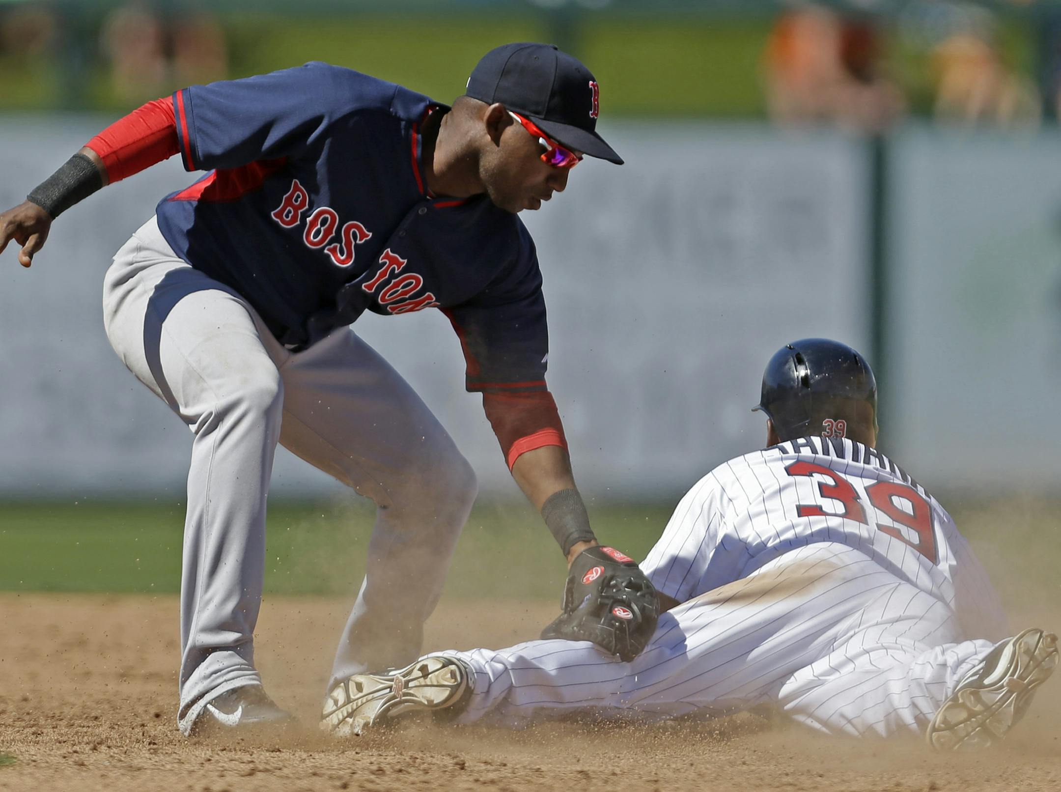 Minnesota Twins Danny Santana (39) steals second base as Boston Red Sox second baseman Jonathan Herrera (10) applies the late tag during an exhibition baseball game in Fort Myers, Fla., Thursday, March 13, 2014. (AP Photo/Gerald Herbert)