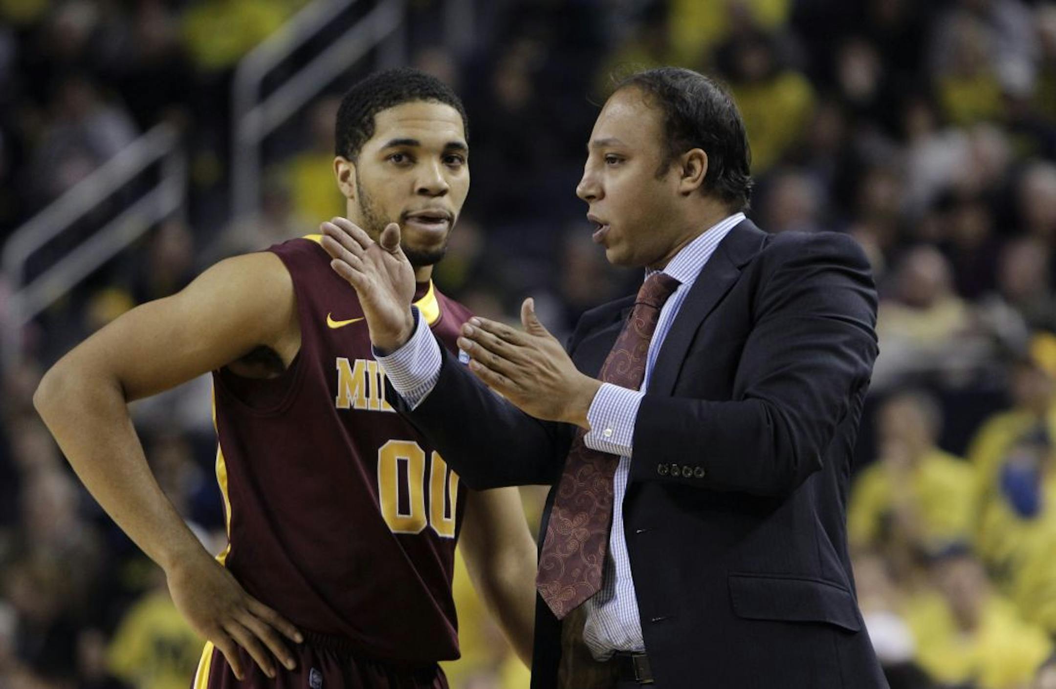 Minnesota assistant coach Saul Smith talked to guard Julian Welch during a game last year.
