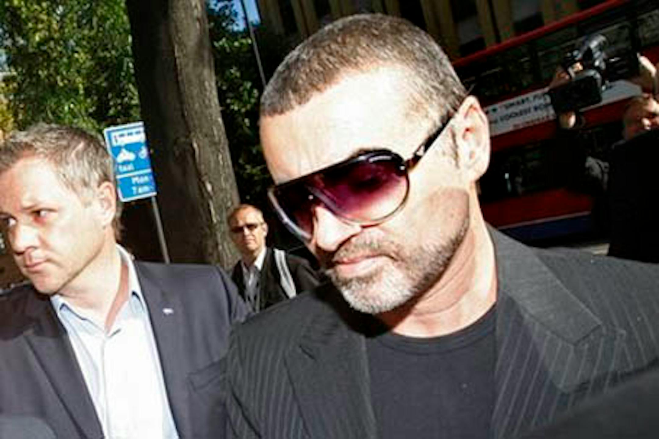 Geo. Michael leaving court. (AP Photo)