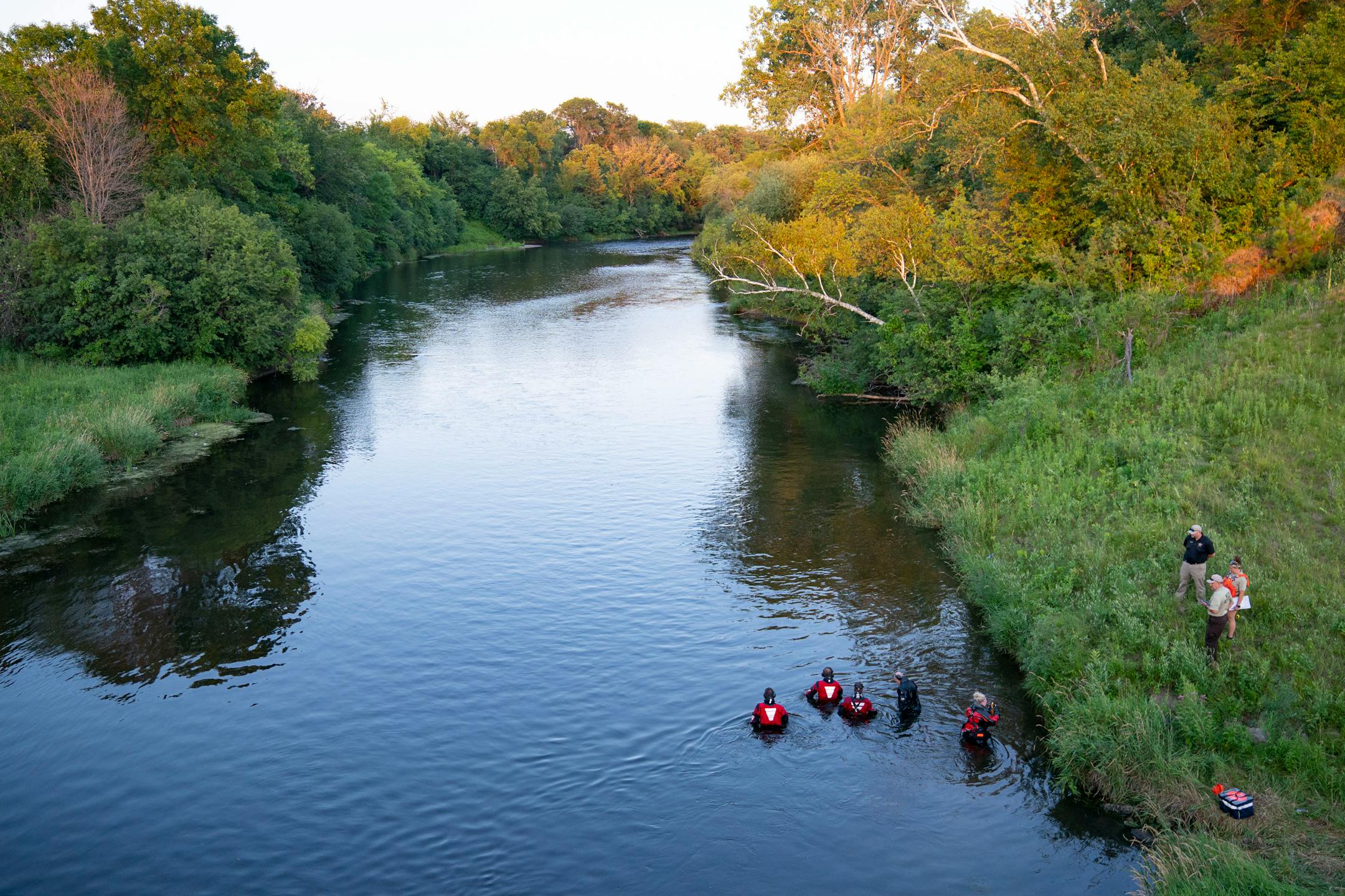Water Recovery authorities comb the Apple River with metal detectors after five people were stabbed while tubing down the river Saturday, July 30, 2022 in Somerset, WI.   ]