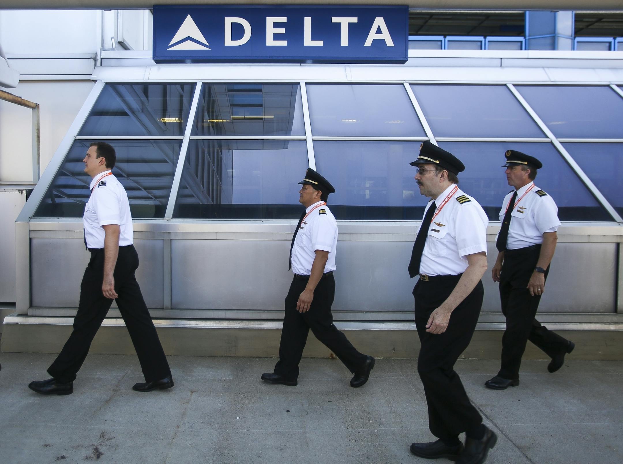 Pilots walk back inside terminal one after completing a one hour shift of silently marching.