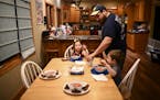 Steve Denzine, a Sandstone prison employee, served up dinner for his wife, Beth, and their two children, Robbie, 3, and Stella, 6, Wednesday night.