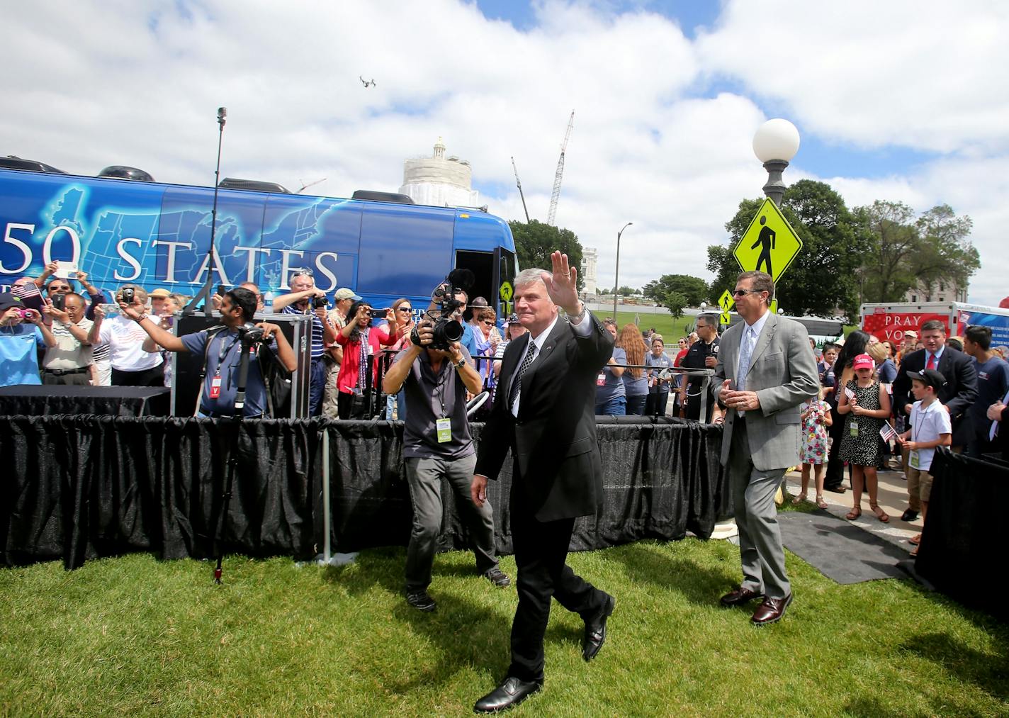 The Rev. Franklin Graham walked from his bus and towards the podium as he hosted a day of prayer, encouraging the throng of Christians gathered to get out and vote and become involved in politics on the local level Thursday, June 16, 2016, in the lower mall outside the State Capitol in St. Paul, MN.