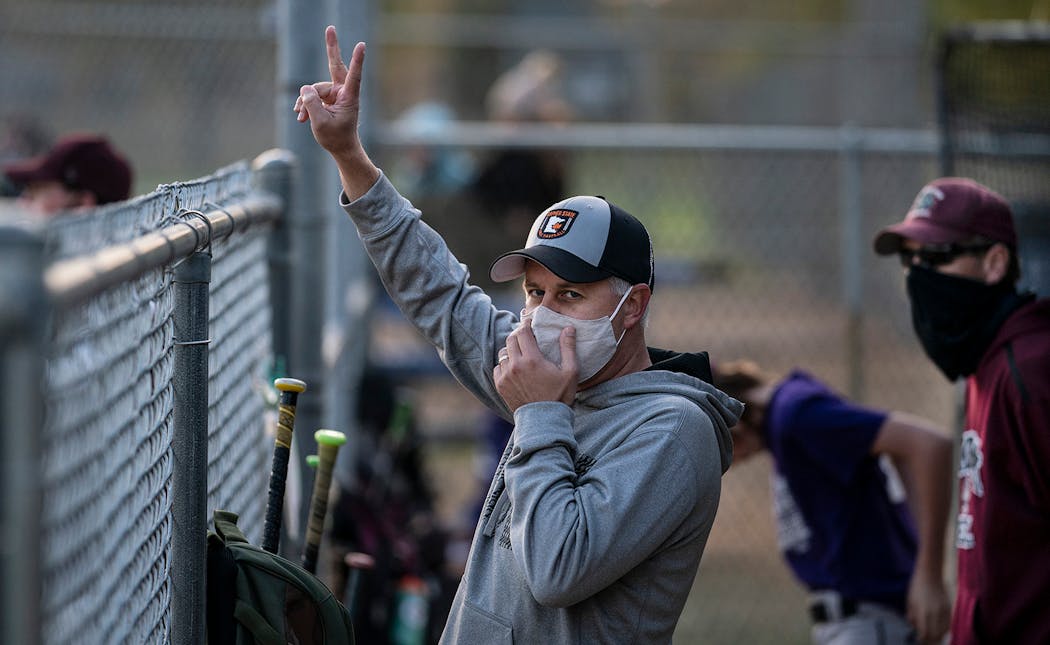Chris Ordner signals two outs to the Bulldogs players on the field.