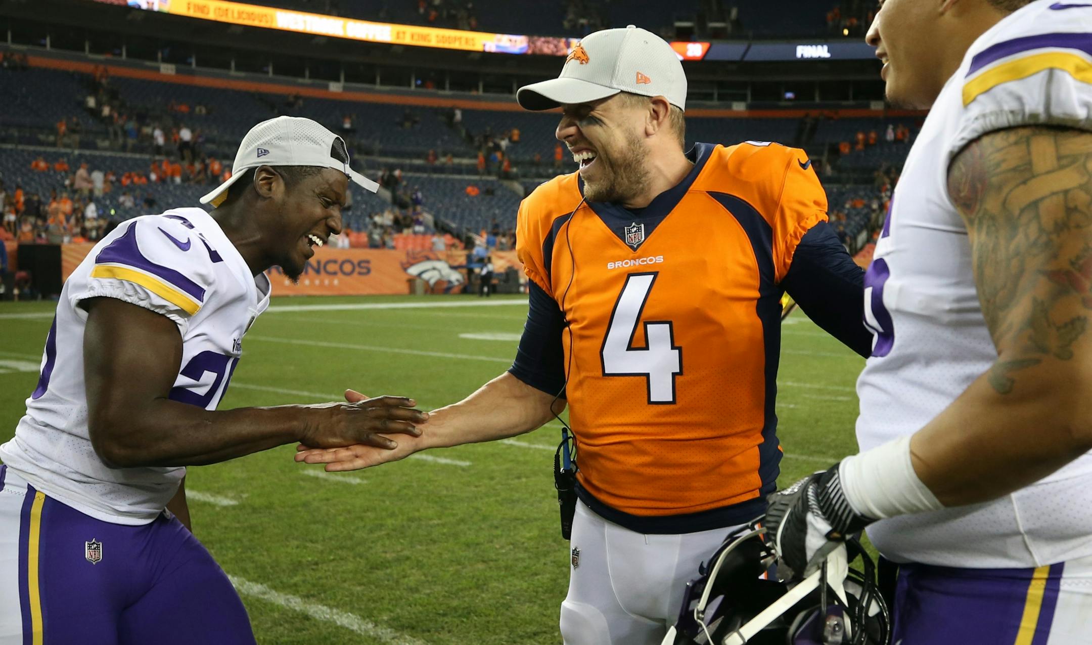 Minnesota Vikings defensive back Xavier Rhodes (29) joked with Denver Broncos quarterback Case Keenum (4) after the game Saturday August 11, 2018 at Broncos Stadium at Mile High in Denver, CO.