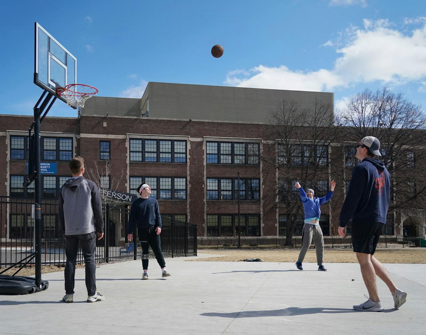 Shooting around together while staying appropriately distant, from left, Mac Doherty, Luke Bishop, Isaac Siegel and Jack Streibeich got in some basketball at Jefferson Community School in Minneapolis on Saturday.