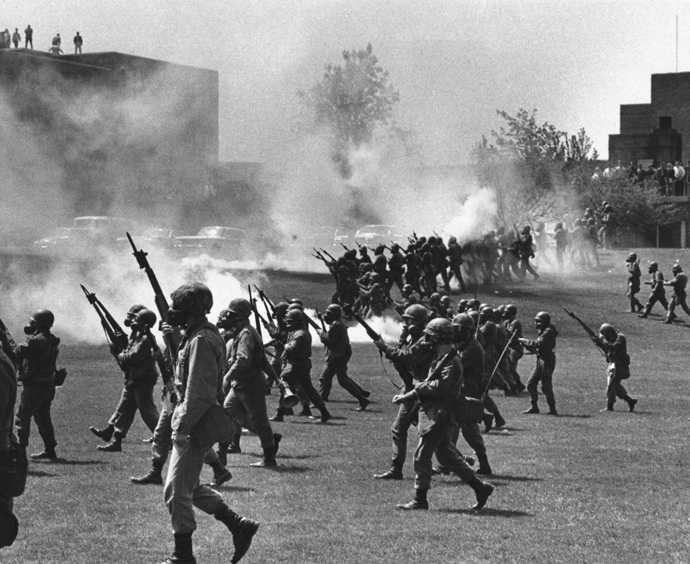 FILE - In this May 4, 1970 file photo, Ohio National Guard soldiers move in on war protestors at Kent State University in Kent, Ohio. Four persons were killed and multiple people were wounded when National Guardsmen opened fire. The school, about 30 miles southeast of downtown Cleveland, had planned an elaborate multi-day commemoration for the 50th anniversary Monday, May 4, 2020. The events were canceled because of social distancing restrictions amid the coronavirus pandemic. Some events, activ