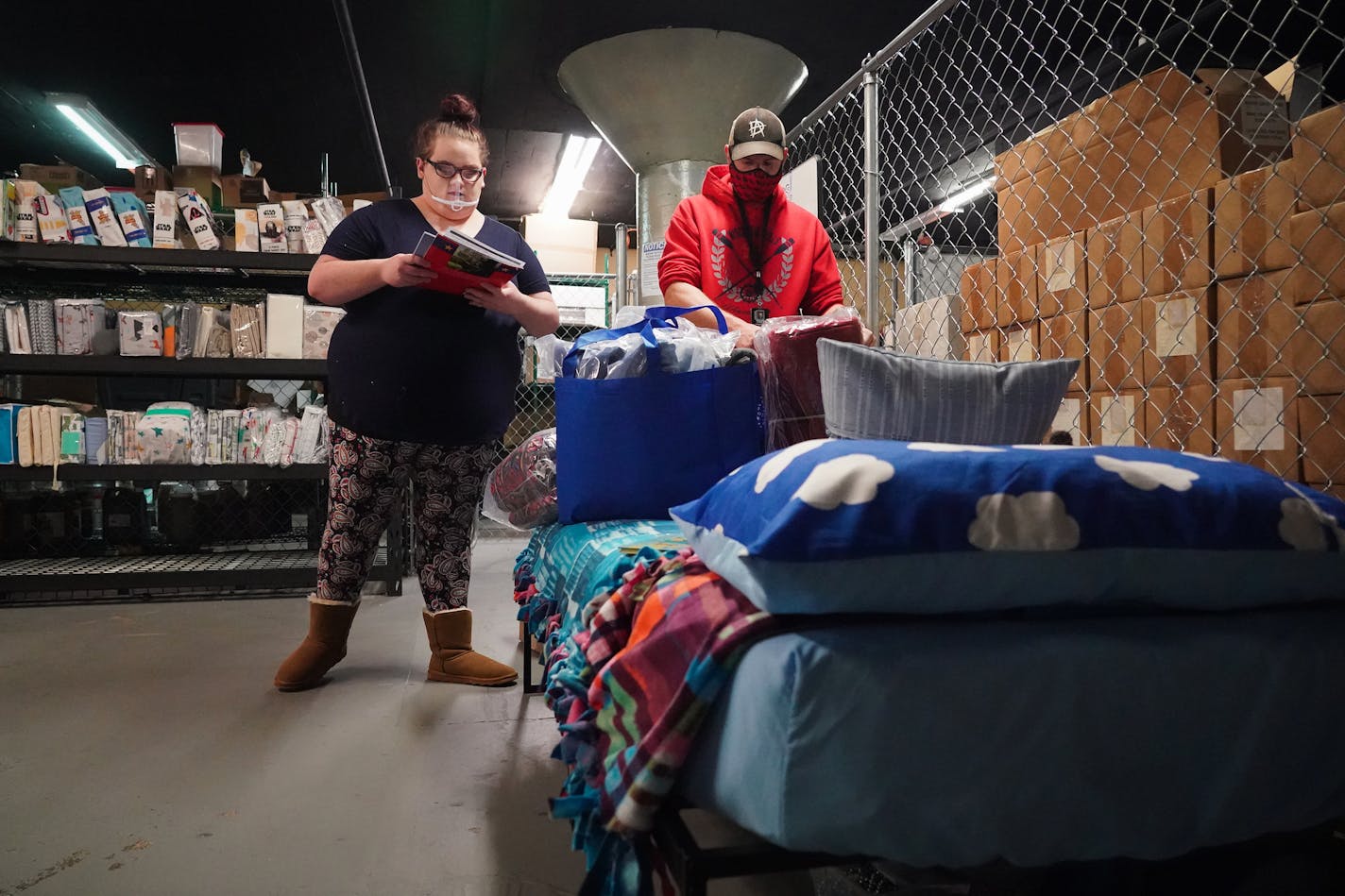 Volunteers Maddison Schug (left) and Corey Sandgren went through a checklist of items that were packed in bags before being delivered to children through My Very Own Bed. ] Shari L. Gross • shari.gross@startribune.com My Very Own Bed, a nonprofit that provides beds to children ages 2-17 who have recently moved into permanent housing, held a volunteer event on Thursday, Nov. 19, 2020, for Give to the Max Day. A group of Eden Prairie students from the Tassel Program (an education, training, employ