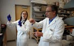 Purdue University biochemistry graduate student Emma Lendy talks with Andy Mesecar, one of the leading scientists identifying protein targets for pote