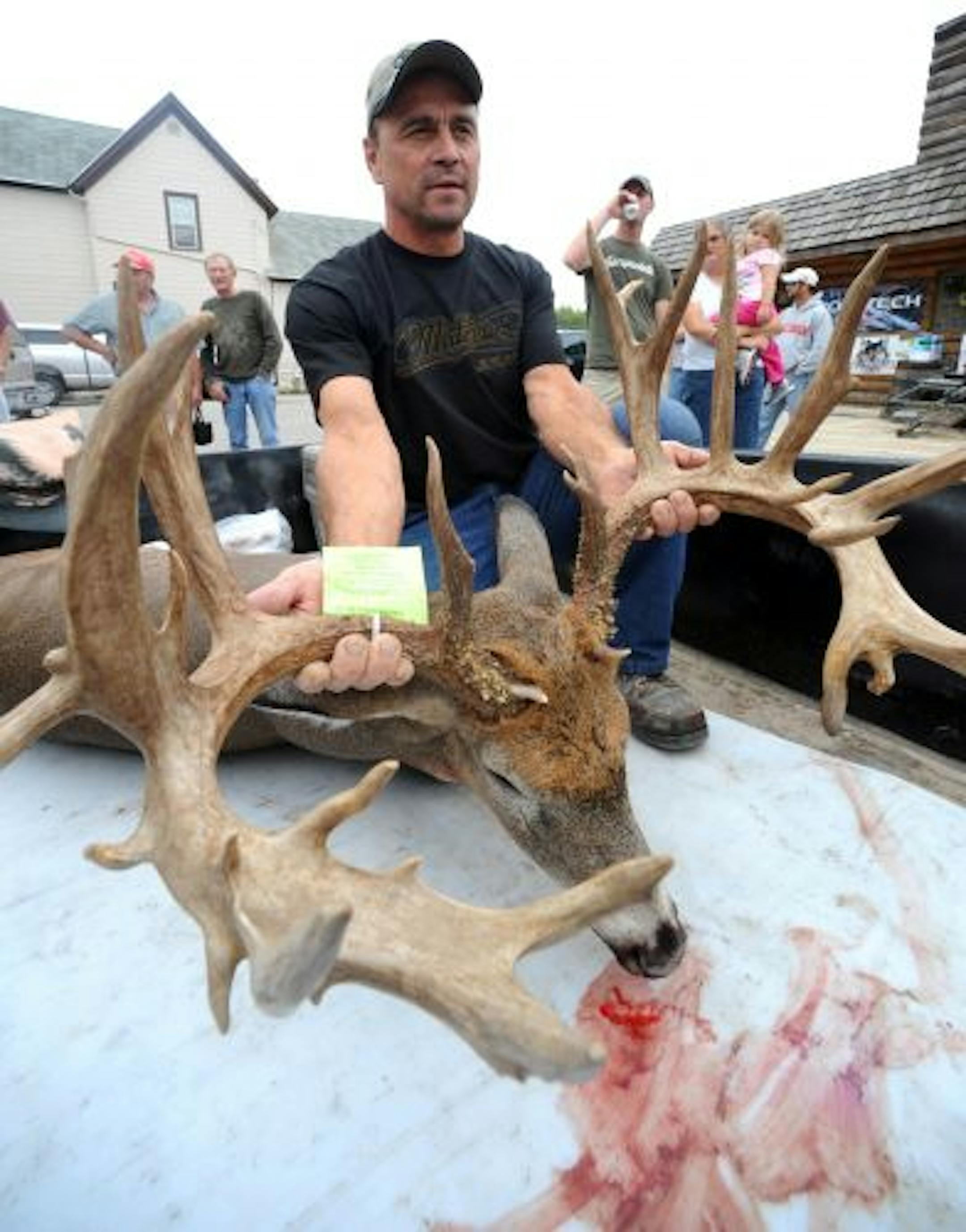 Wayne Schumacher of Fond du Lac, Wis., displays the 30-point rack of the deer, which he killed with his bow.