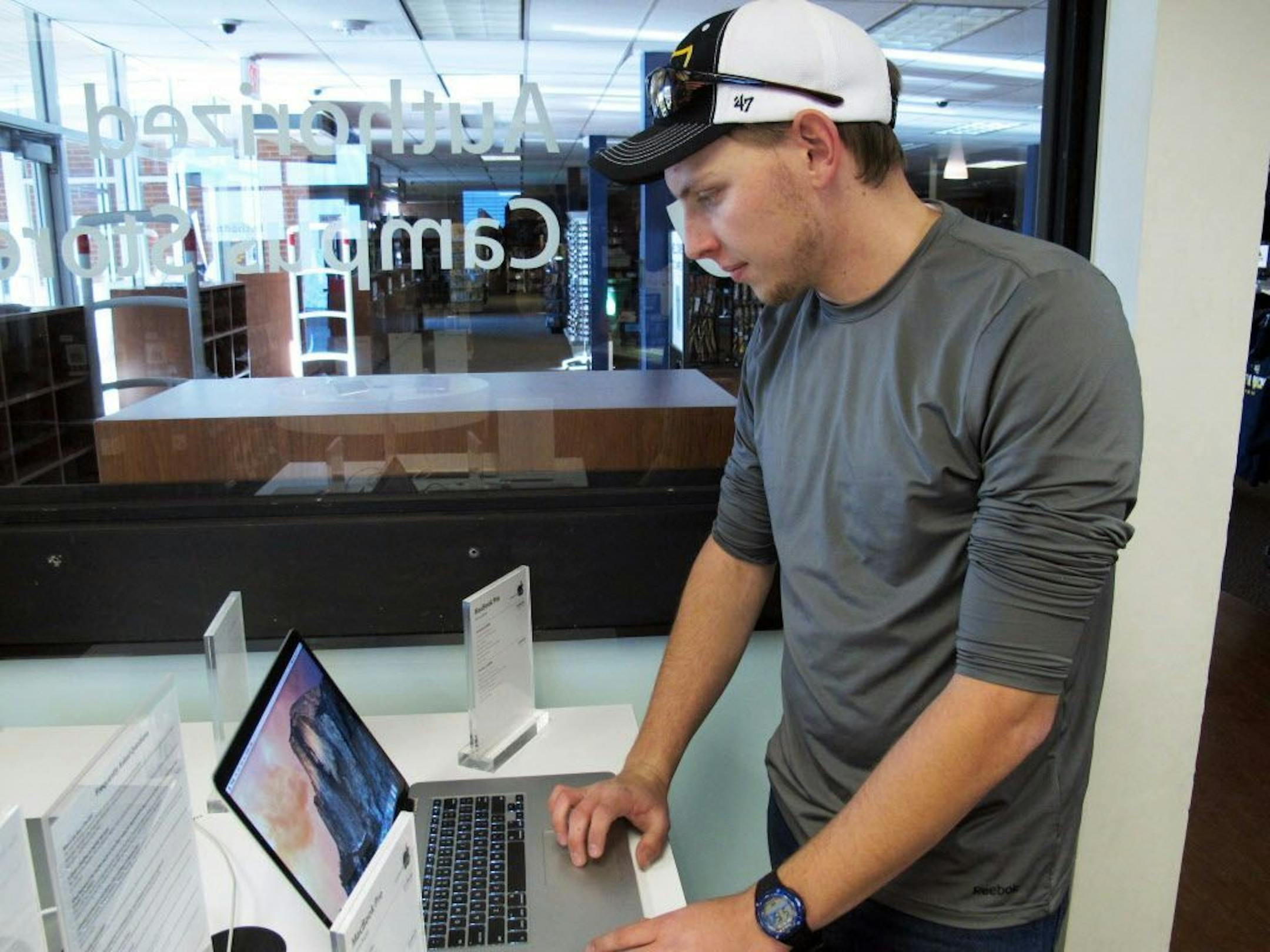 Zak Holland opens up a computer at a store on the Northern Arizona University campus in Flagstaff, Ariz., Wednesday, Feb. 25, 2015.