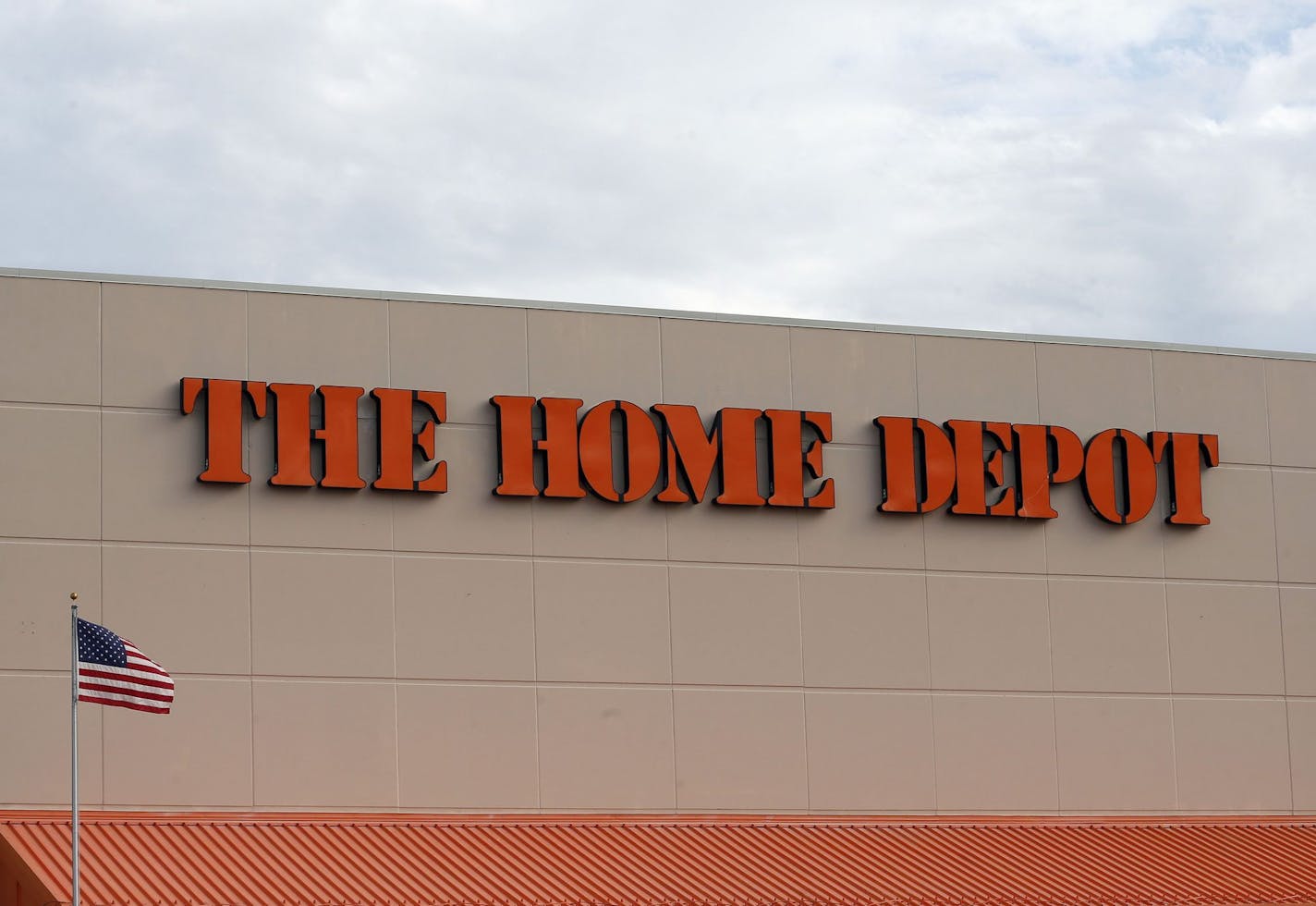 FILE - In this Aug. 27, 2019 file photo, the Home Depot logo is shown on a store in Bloomington, Minn. Home Depot's fiscal second-quarter sales surged to easily top Wall Street's expectations as consumers continued working on home projects and gardening amid the coronavirus outbreak. (AP Photo/Jim Mone, File)