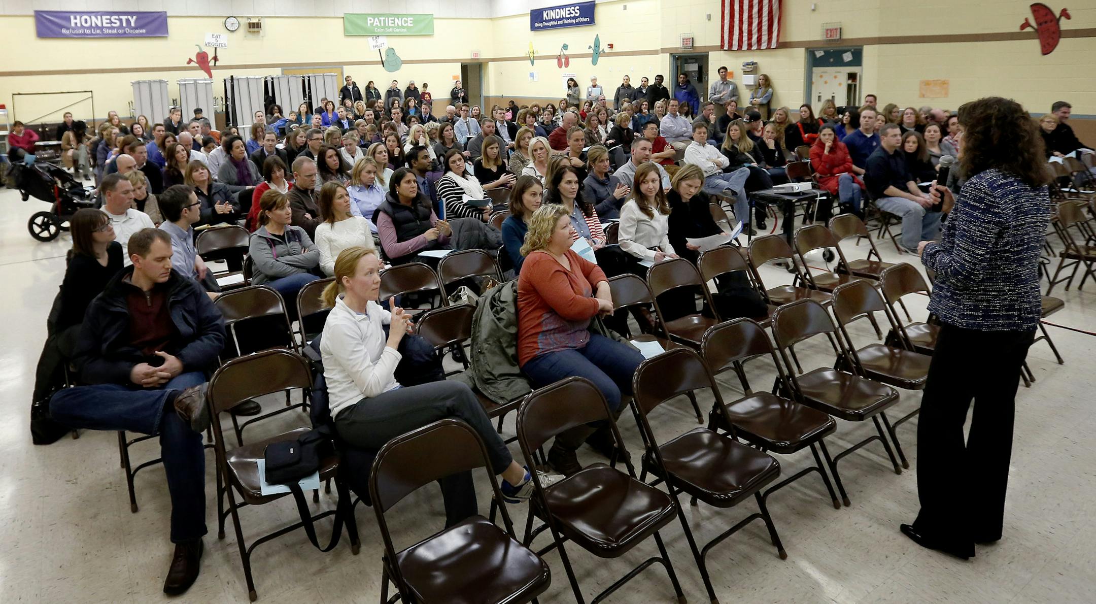 Osseo Schools Superintendent Kate Maguire fielded questions during a meeting with parents in the gym of Basswood Elementary School in Maple Grove on Tuesday evening. ] CARLOS GONZALEZ cgonzalez@startribune.com - January 14, 2013, Maple Grove, Minn., Basswood Elementary School, Residents of five well-to-do neighborhoods near Plymouth are concerned over the fact that Osseo Area Schools wants to move them to another elementary school, one that is decidedly less white or affluent. The move is part o