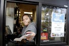 A cashier returns a credit card and a receipt at a McDonald's window, where signage for job openings are displayed, Thursday, Jan. 3, 2019, in Atlanti