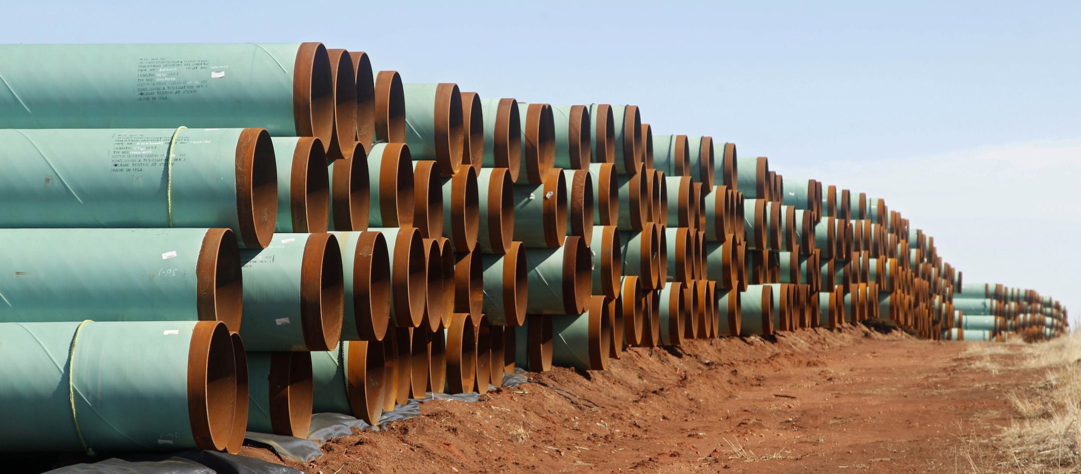 FILE - In this Feb. 1, 2012 file photo, miles of pipe ready to become part of the Keystone Pipeline are stacked in a field near Cushing, Okla. Oklahoma leaders are praising the renewed momentum in Congress to approve the northern leg of the Keystone XL pipeline, although the project will have only a minimal economic impact on the Sooner State.(AP Photo/Sue Ogrocki, File) ORG XMIT: OKSO361 ORG XMIT: MIN1411201206239643