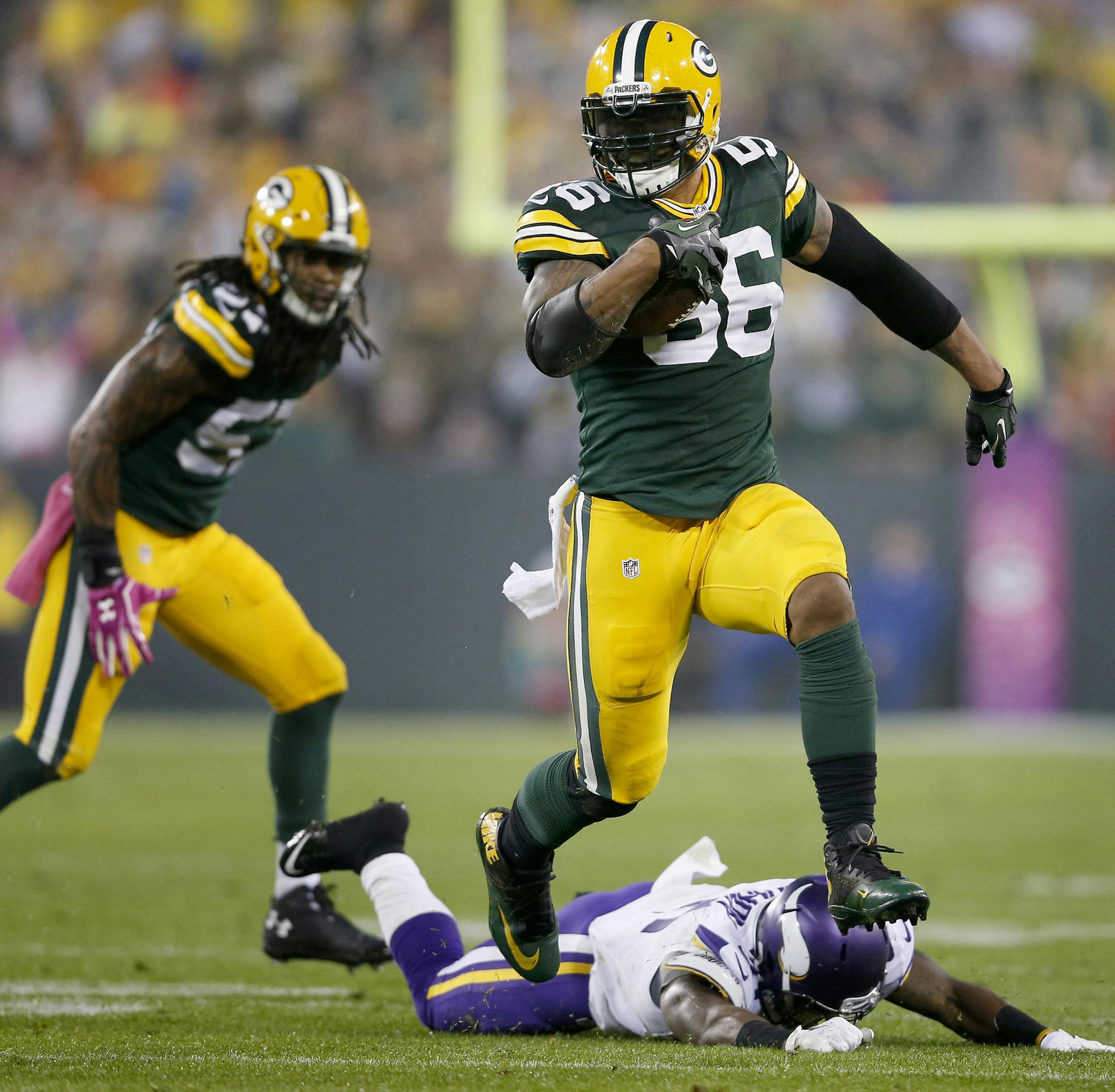 Julius Peppers (56) ran for the end zone after intercepting a Christian Ponder pass and returning it 49-yards for a touchdown in the second quarter. ] CARLOS GONZALEZ cgonzalez@startribune.com - October 2, 2014 , Green Bay, WI NFL, Lambeau Field, Minnesota Vikings vs. Green bay Packers