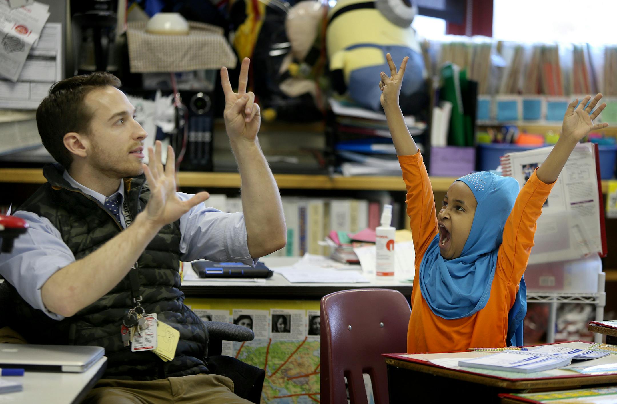 Sullivan ELL teacher James Kindle worked with his class, including Hodo Ashara during math class, Wednesday, January 22, 2014 in Minneapolis, MN. Minneapolis is expanding its pilot program of two classrooms dedicated to Somali students who arrived here without any English. Starting next fall, eight classrooms at Sullivan and Andersen schools will offer classes tailored to getting students up to speed in order to transfer to regular English learner classes. It's one way the district is epxpanding