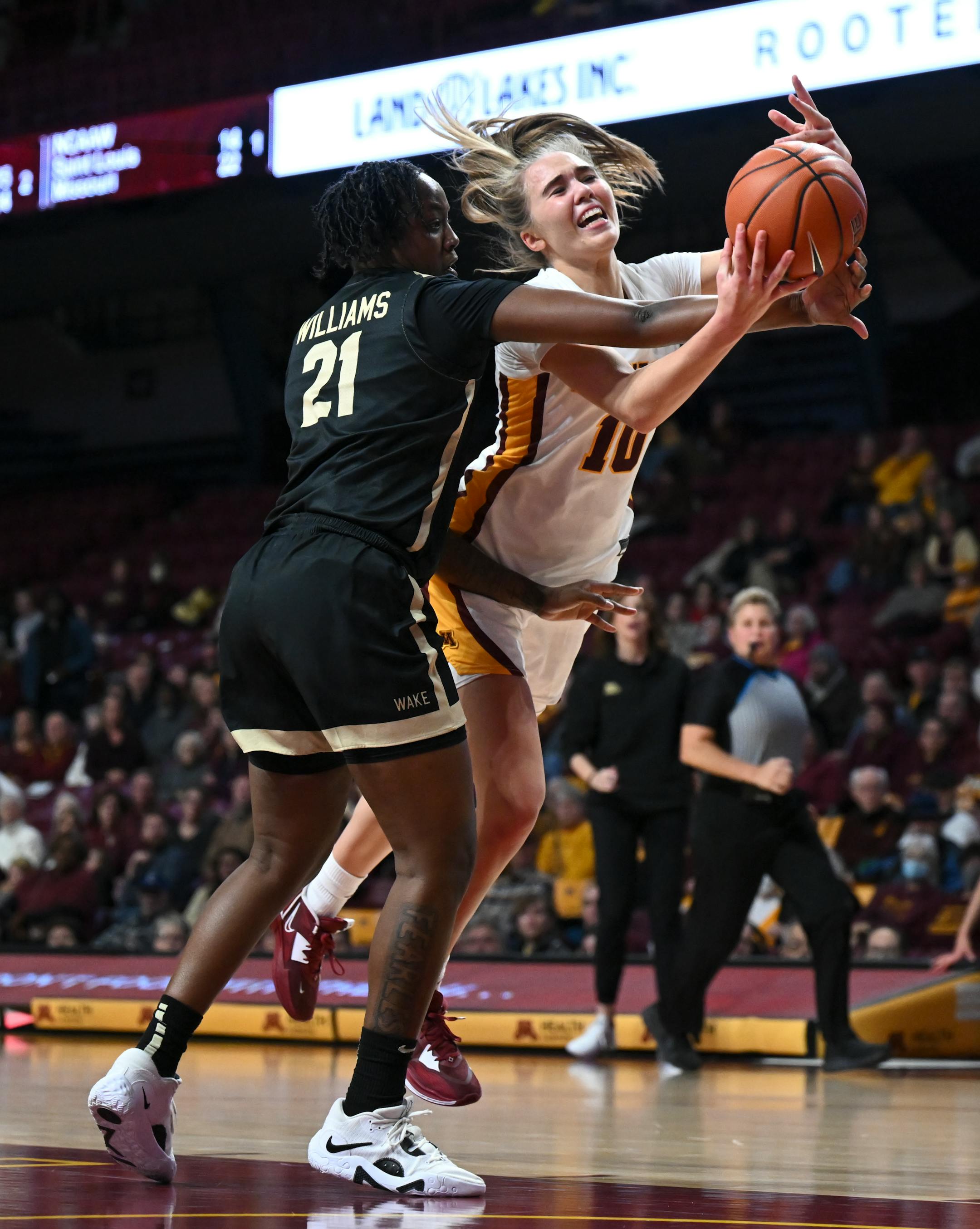 Minnesota Gophers guard Mara Braun (10) is fouled by Wake Forest guard Elise Williams (21) as Braun drives toward the basket during the first half.