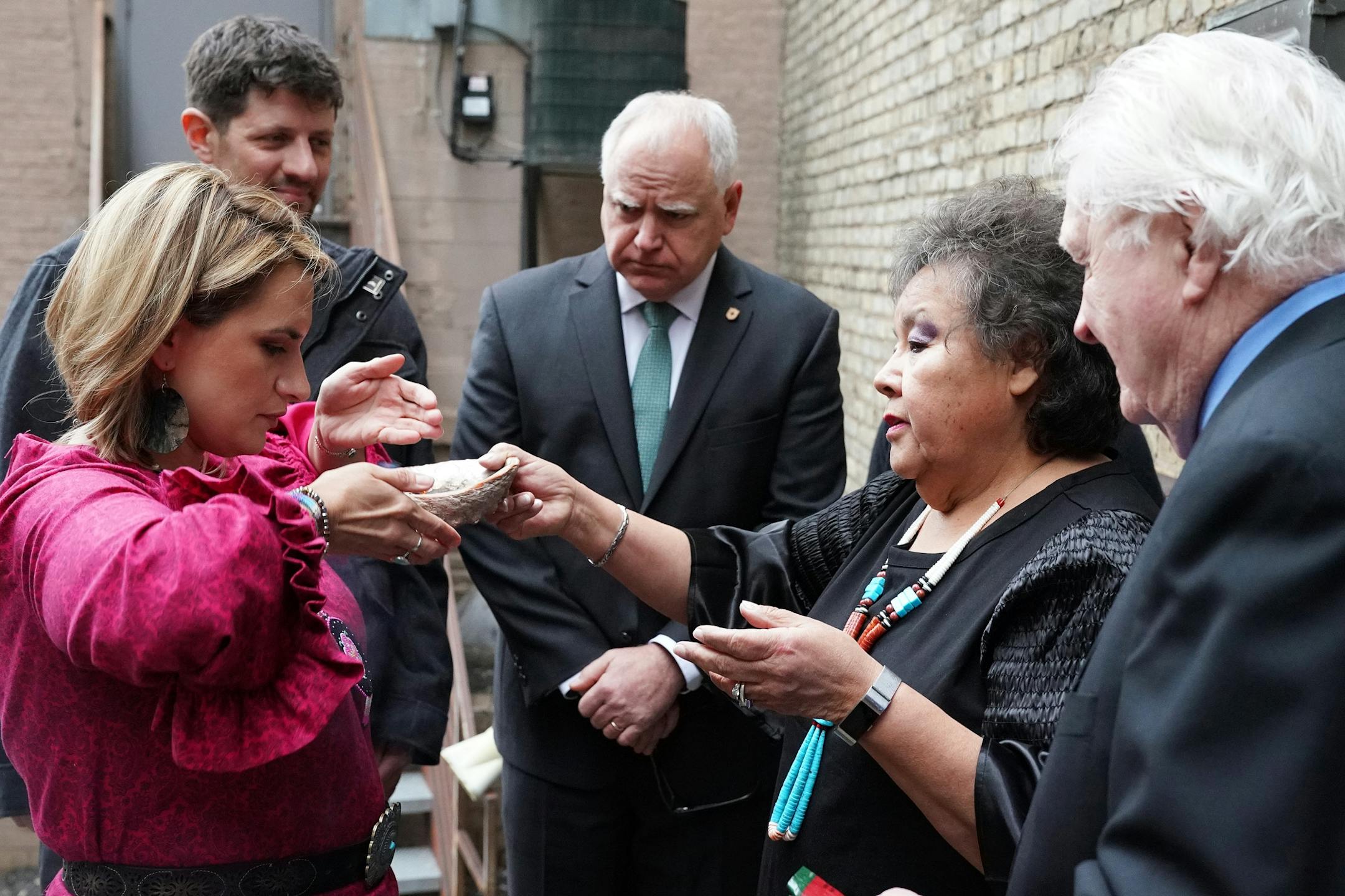 Gov. Tim Walz, his daughter Hope, Lt. Gov. Peggy Flanagan, and her parter Tom Weber took part in a smudging ceremony led by Rev. Marlene Helgemo and Harvey Helgemo behind the Fitzgerald Theater prior to their inauguration in St. Paul, Minn.