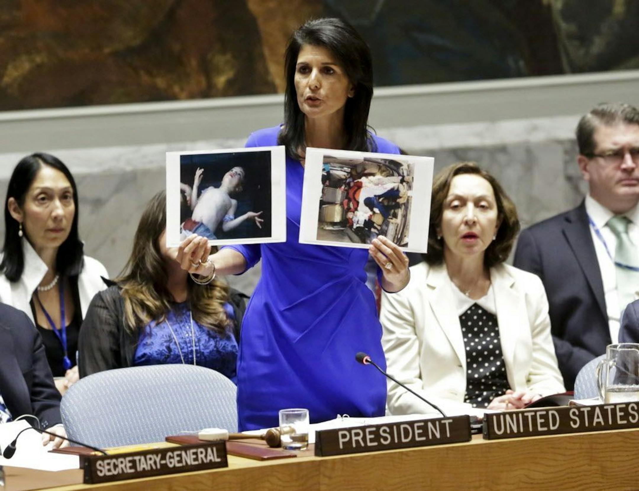 Nikki Haley, United States' Ambassador United Nations, shows pictures of Syrian victims of chemical attacks as she addresses a meeting of the Security Council on Syria at U.N. headquarters, Wednesday, April 5, 2017.