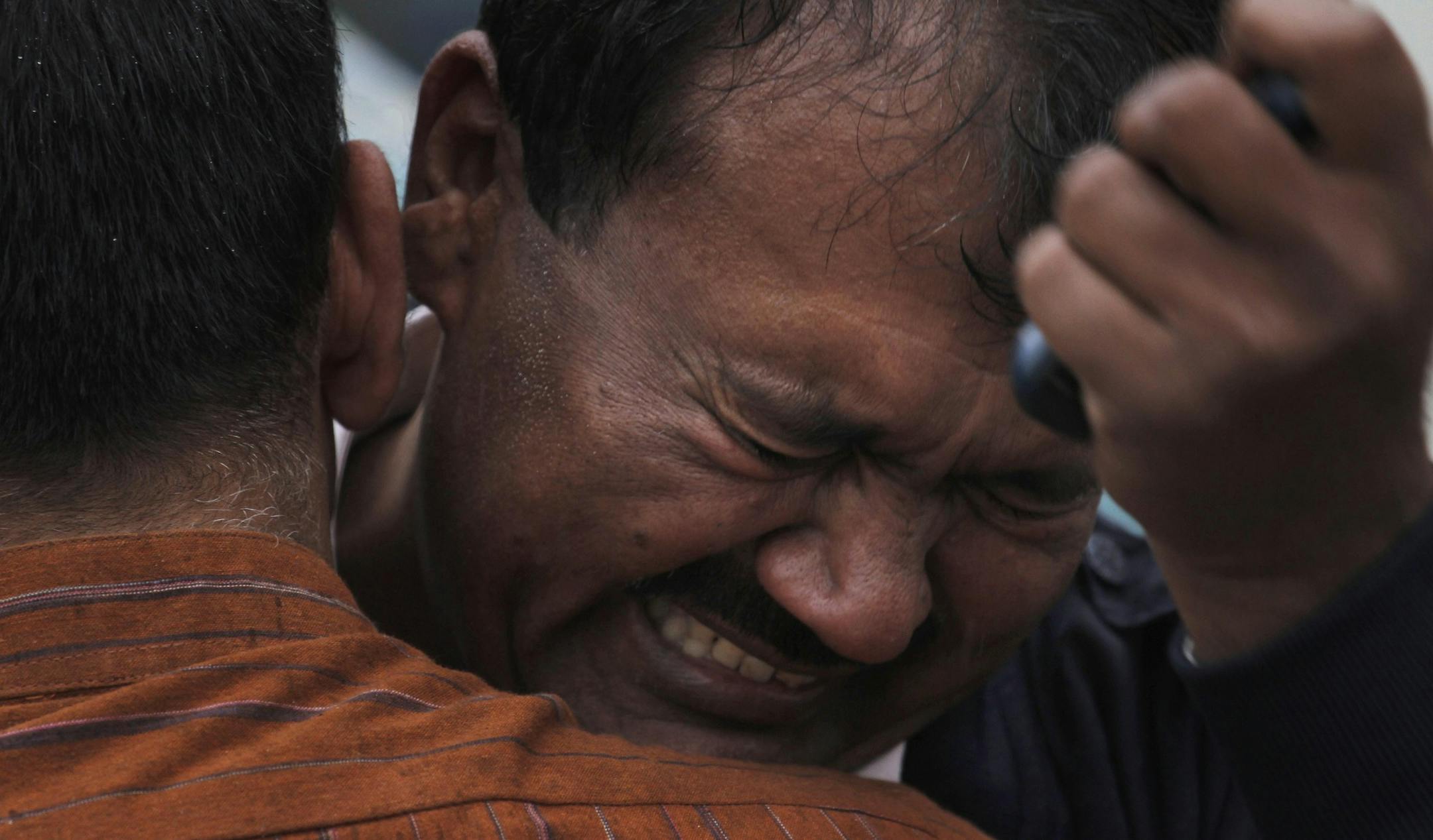 A Pakistani man mourns outside a hospital's morgue, where the bodies of victims of a twin suicide bombing are, in Islamabad, Pakistan, Monday, March 3, 2014.