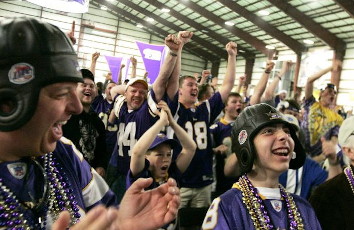 Father and son Jerry and Chris Doffing, 14, of Burnsville celebrate the Minnesota Vikings fist round draft of Percy Harvin of the University of Florida during NFL draft day party at Winter Park.