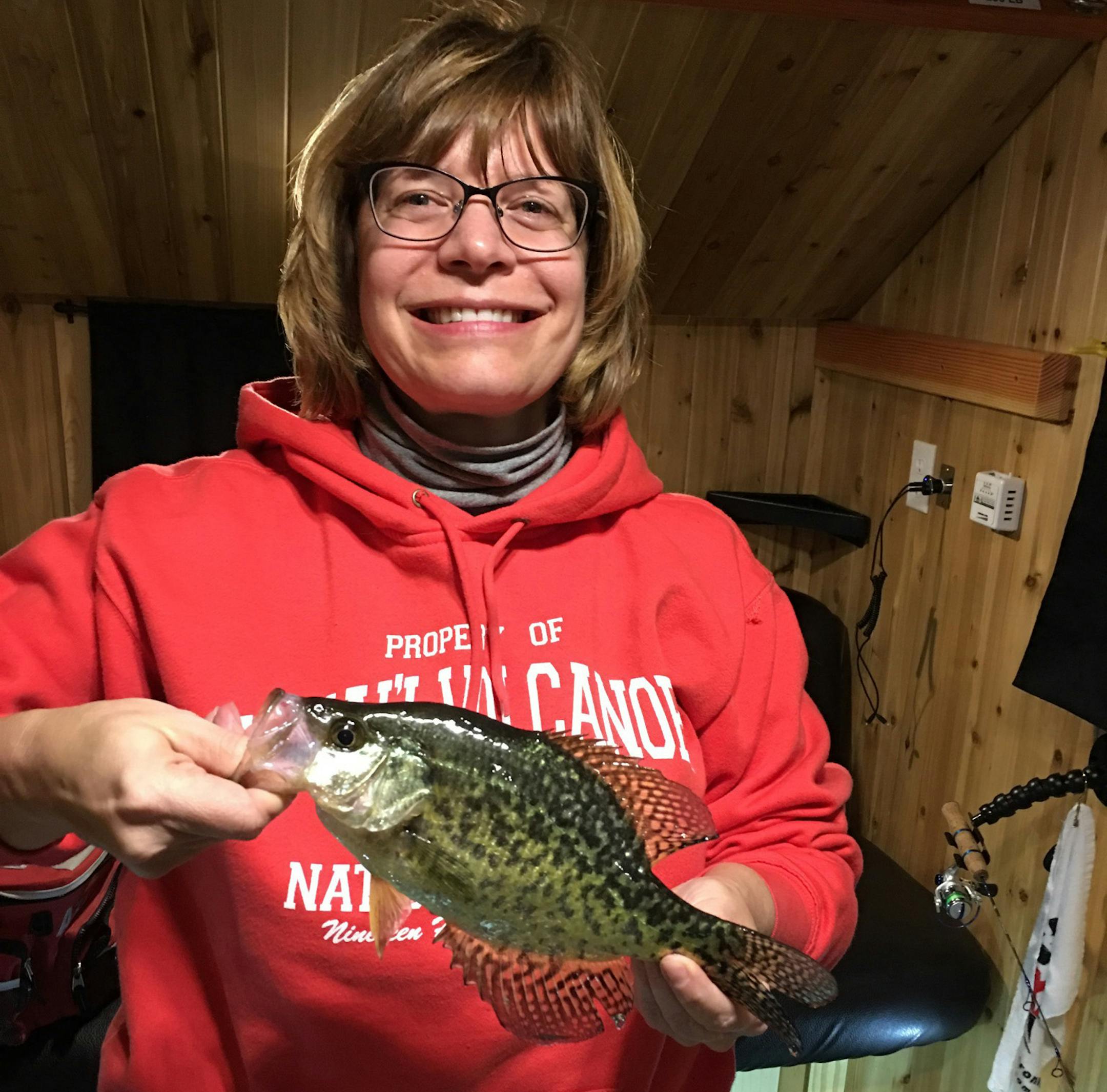 Dianne Kendall with a crappie. Kendall takes part in Ice Queen, a virtual ice fishing tournament for women in Minnesota.