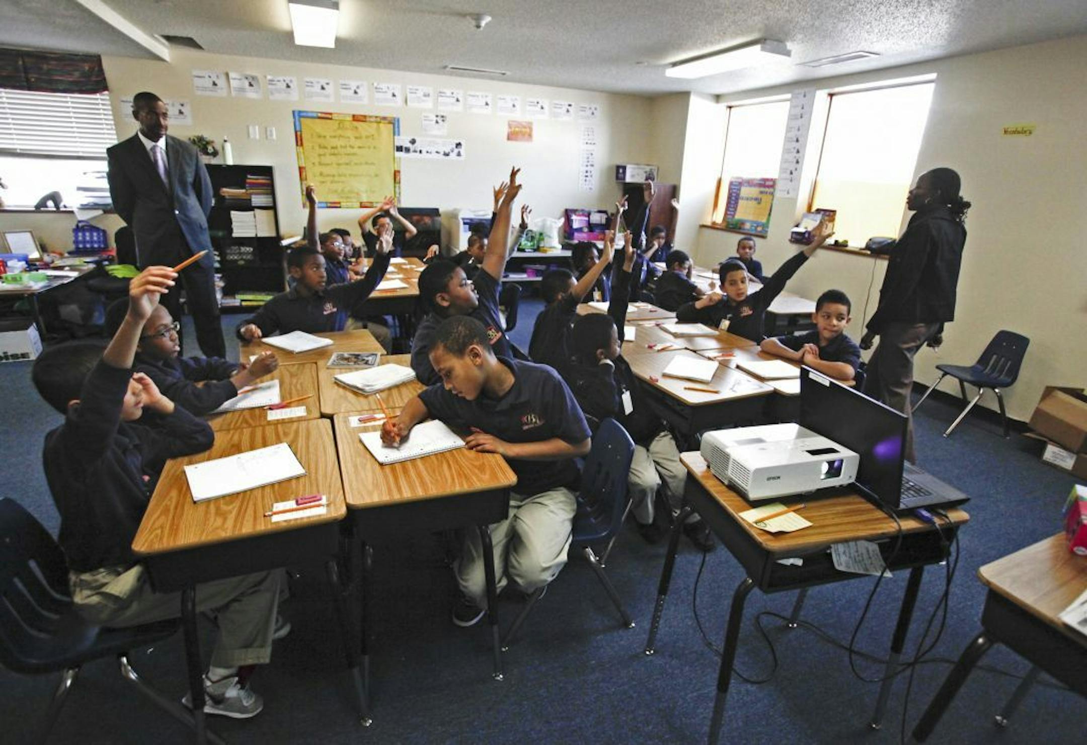Harvest Prep and Best Academy founder and principal Eric Mahmoud, left, watched as Best Academy 4th grade teacher Fatou Diahame, right, worked with students on math Thursday, Dec. 8, 2011 in Minneapolis.